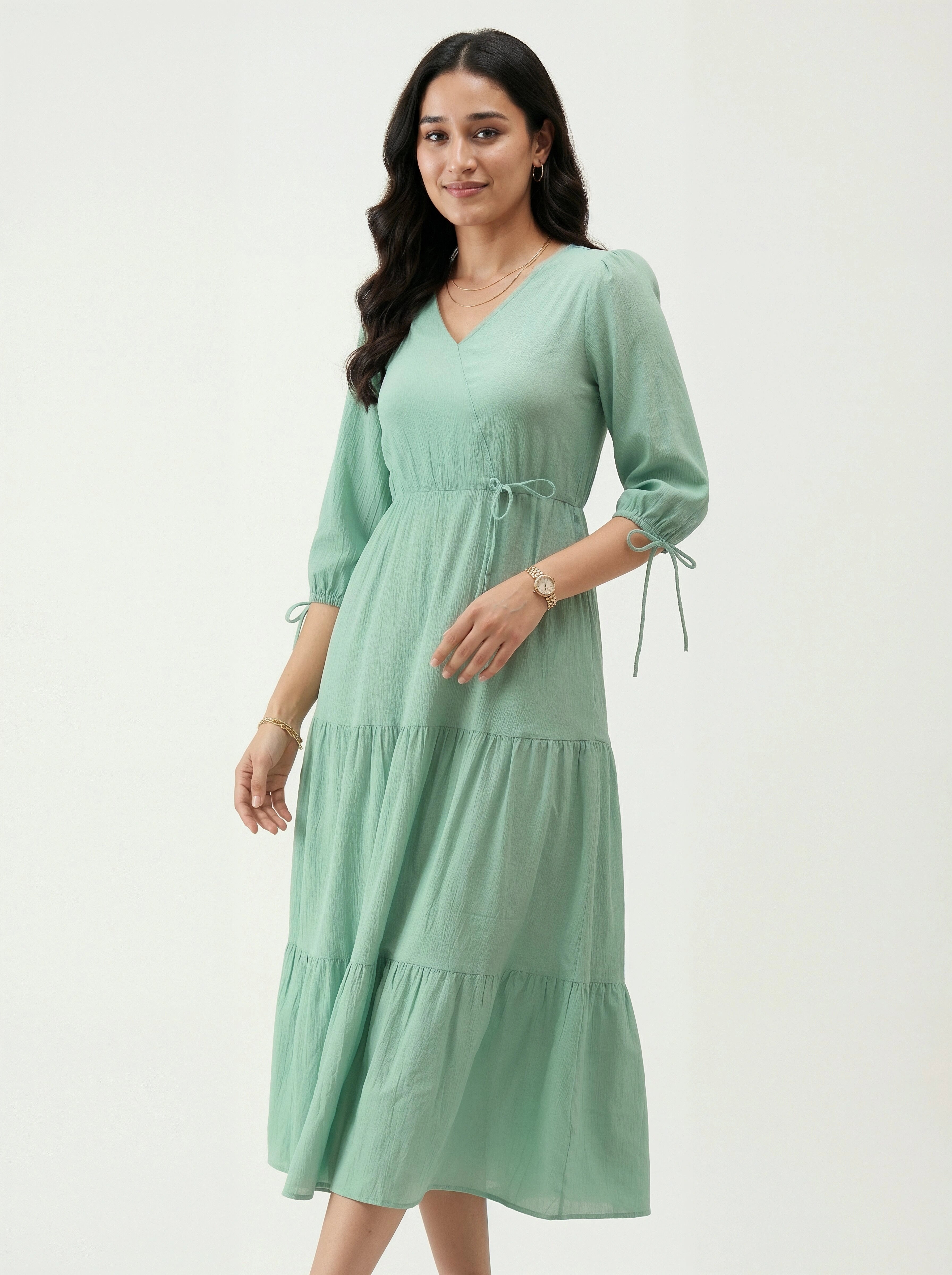 Woman wearing a light green dress on a white background