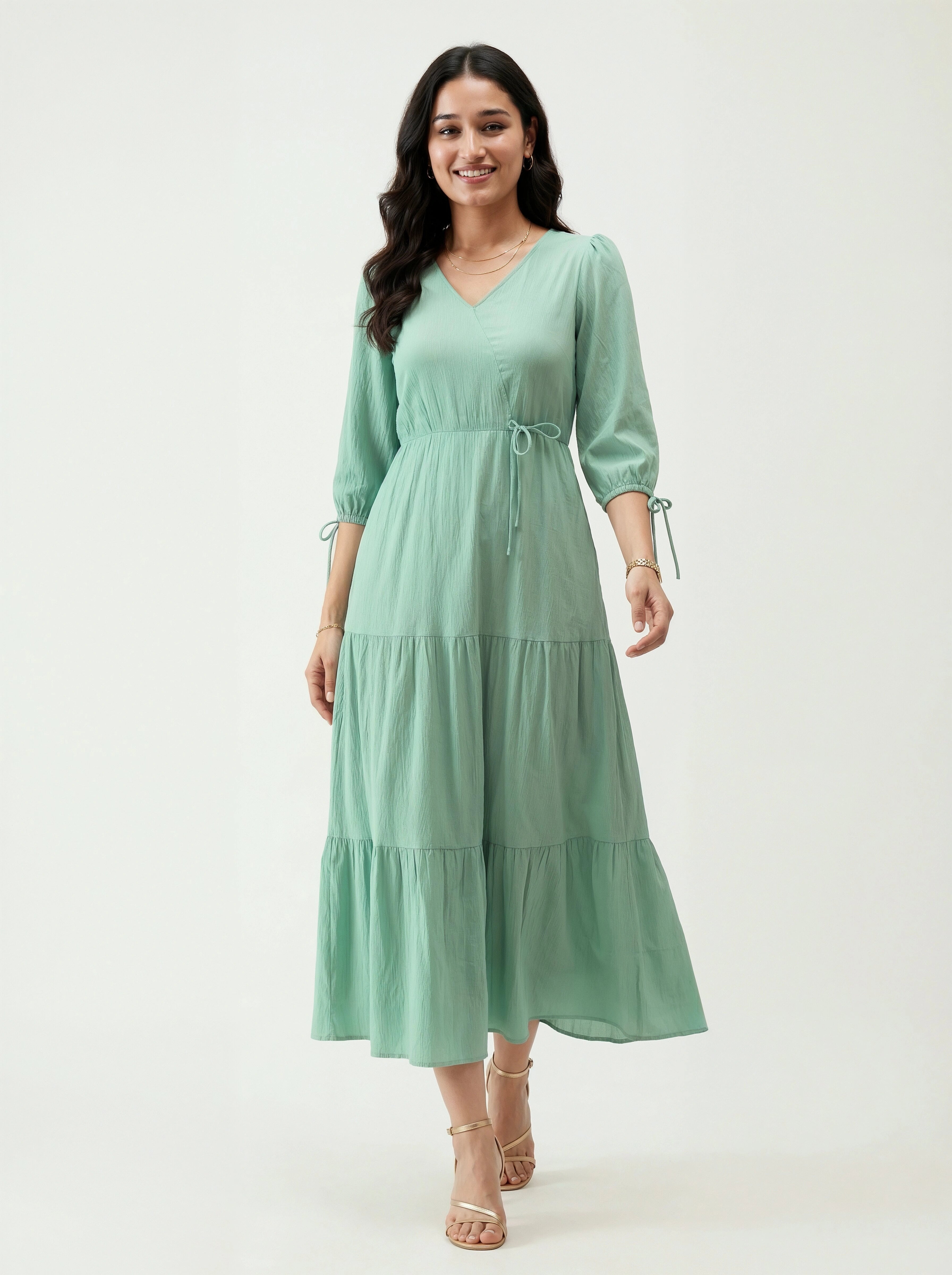 Woman wearing a light green dress on a white background