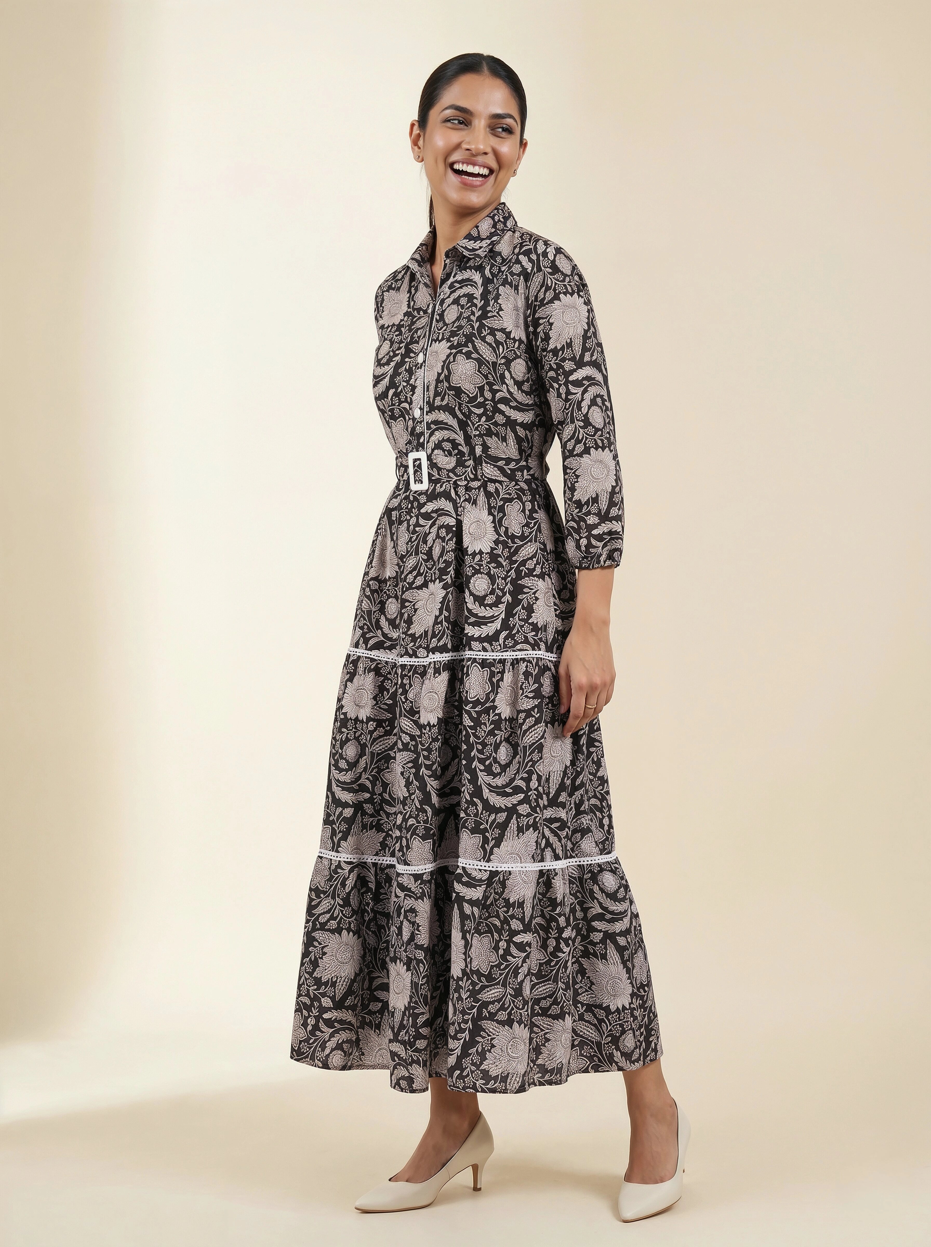 Woman wearing a black and white patterned dress on a beige background