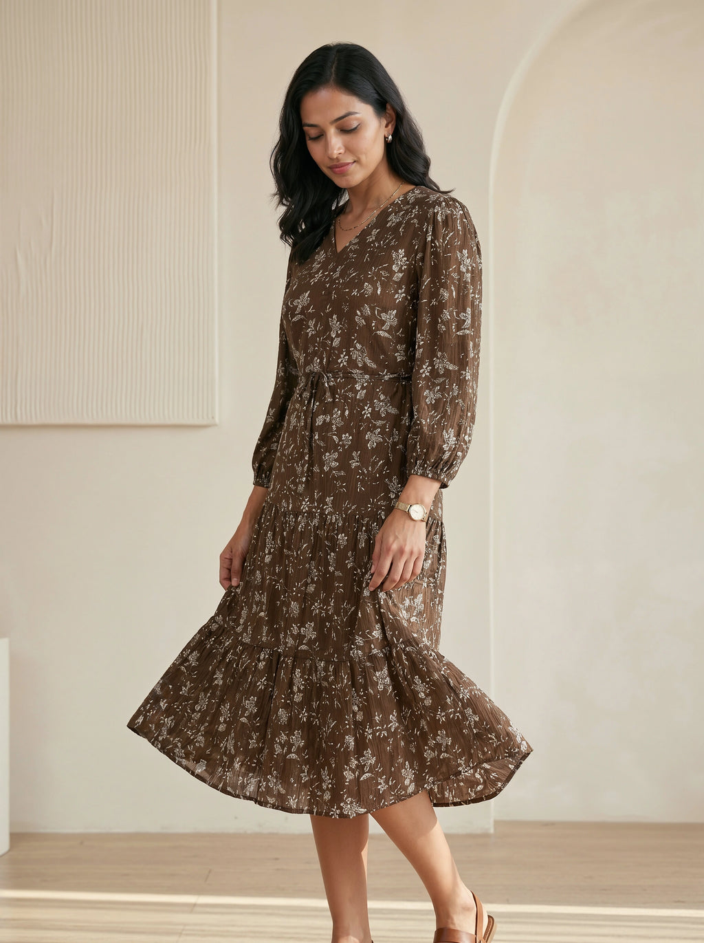 Woman wearing a brown floral dress in an indoor setting
