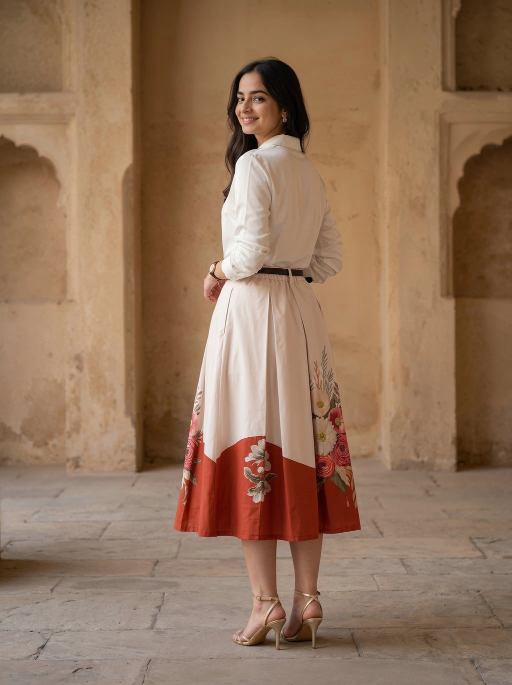 Woman in a traditional outfit standing in an architectural setting