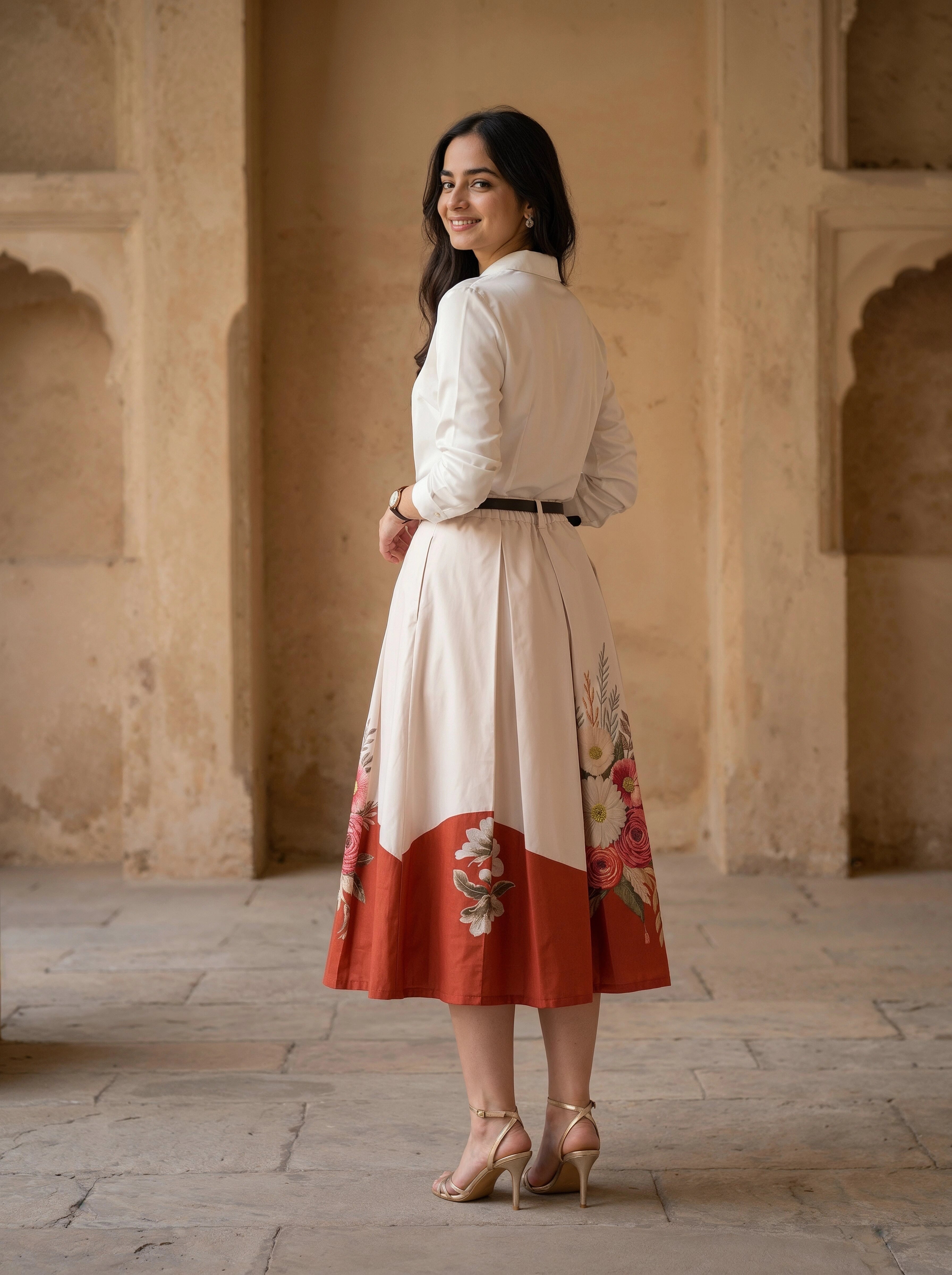 Woman in a traditional outfit standing in an architectural setting