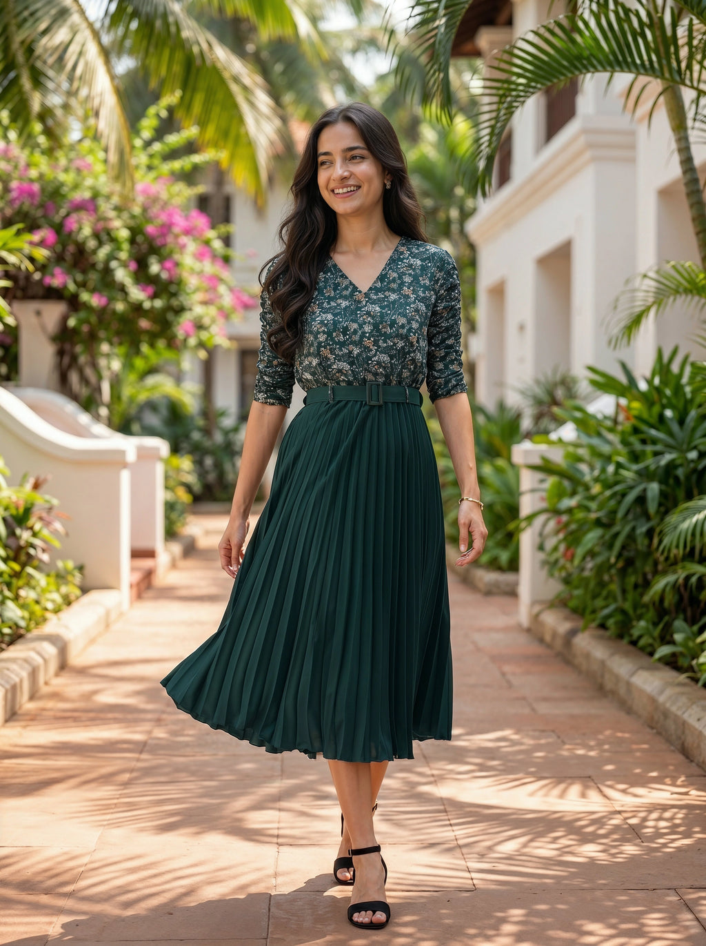 Woman in a green dress standing in a garden setting