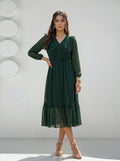 Woman wearing a green dress against a white background