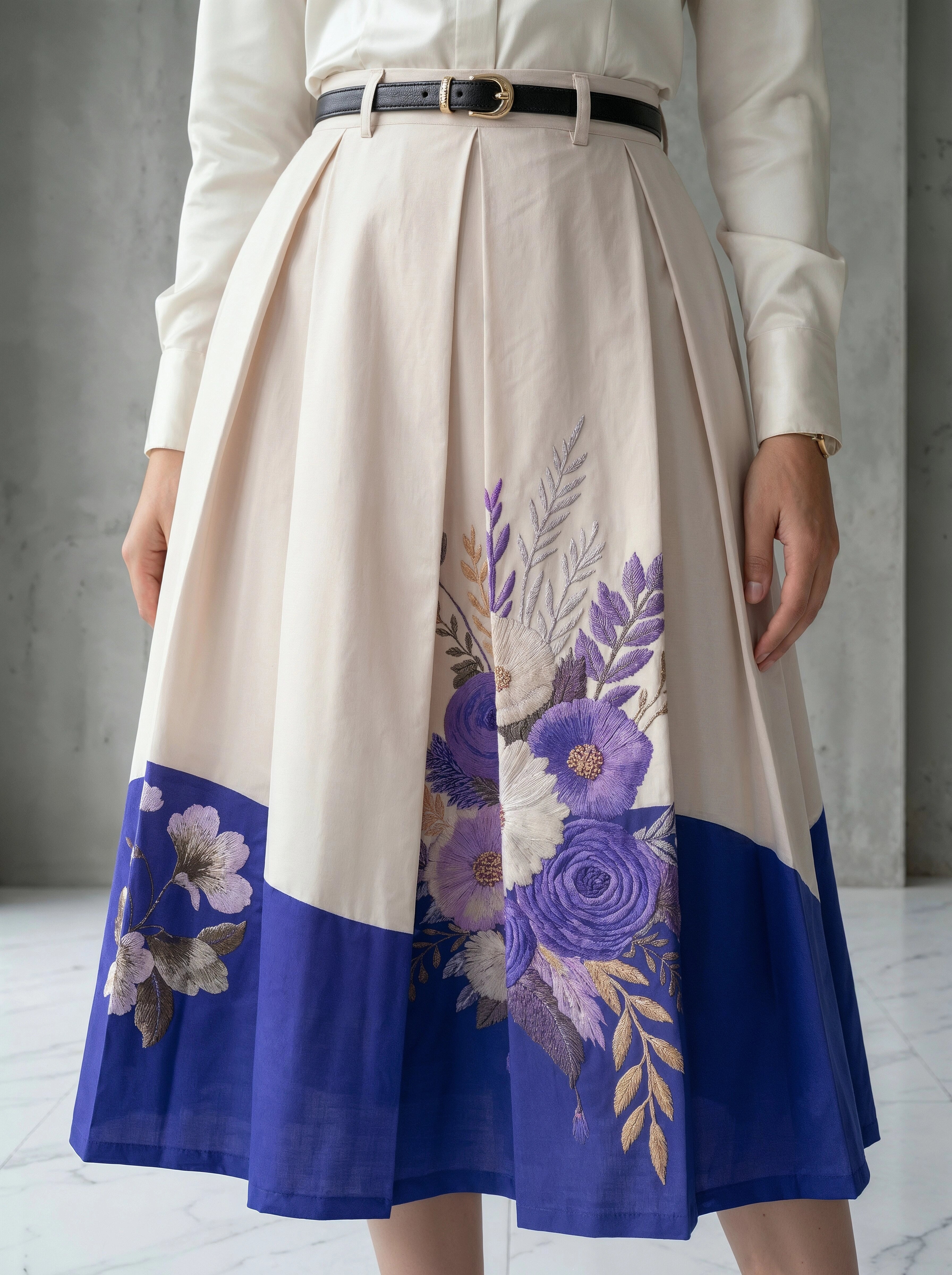 Beige skirt with floral patterns and a blue bottom section worn by a person.