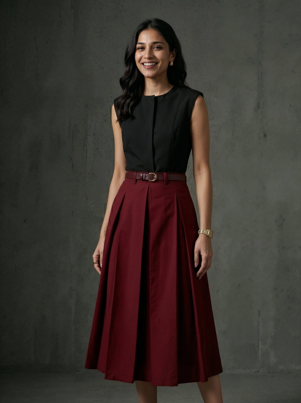 Woman wearing a black top and maroon skirt against a dark background