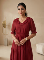 Woman wearing a red dress in an indoor setting