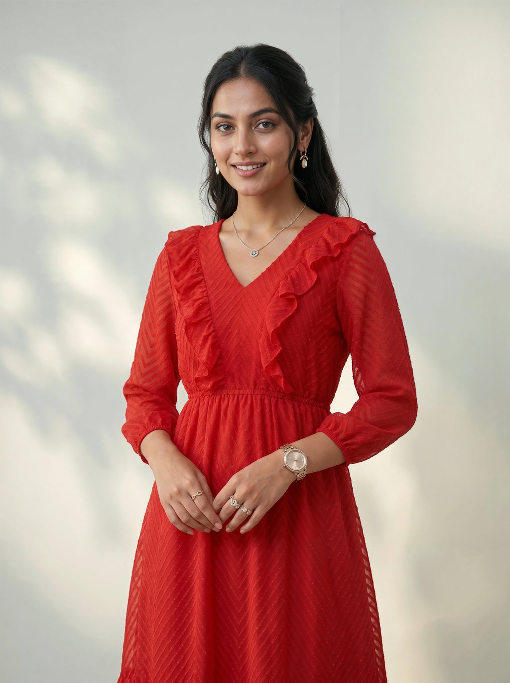 Woman wearing a red dress with a blurred light background
