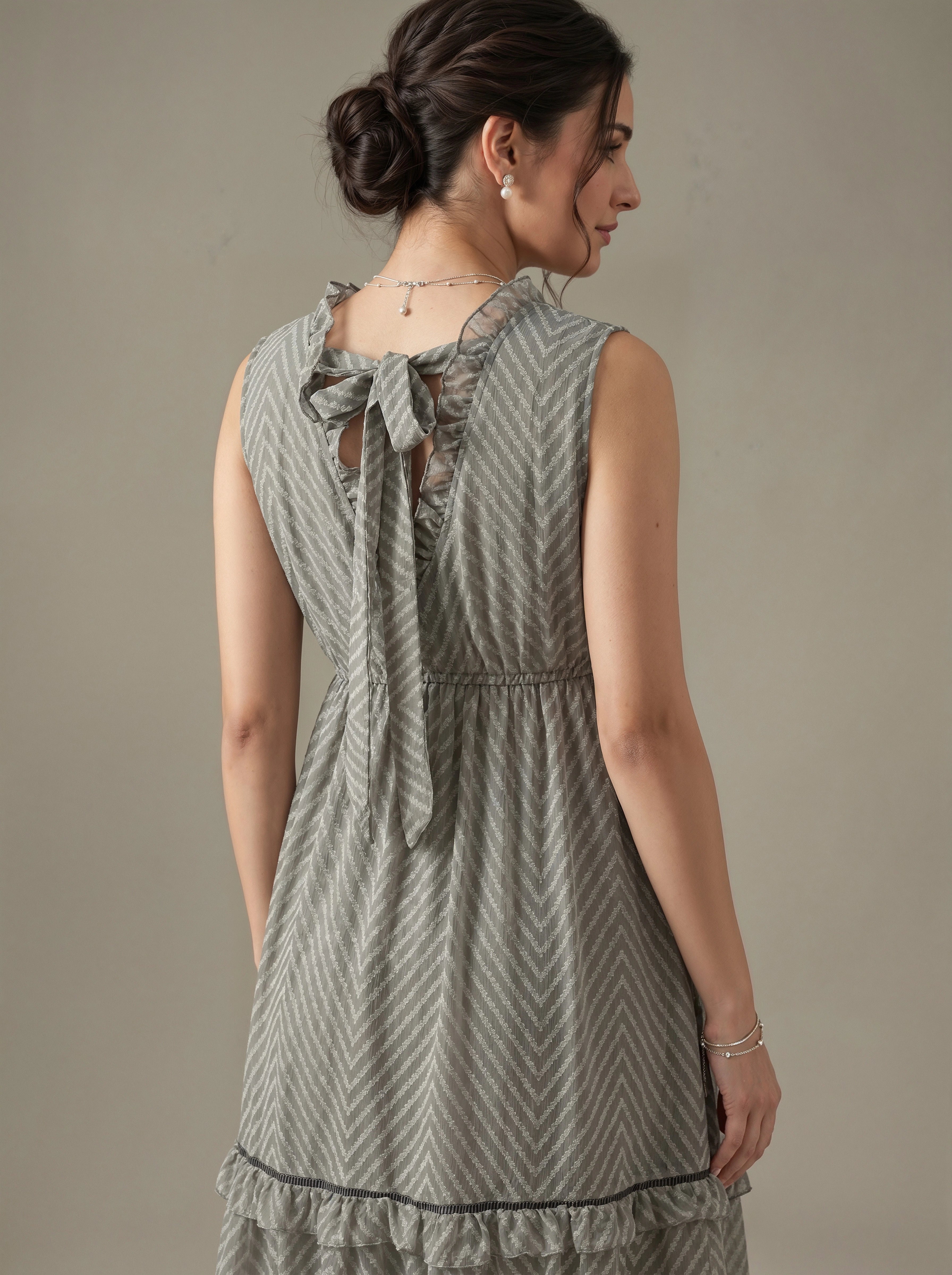 Woman wearing a patterned dress with a neutral background