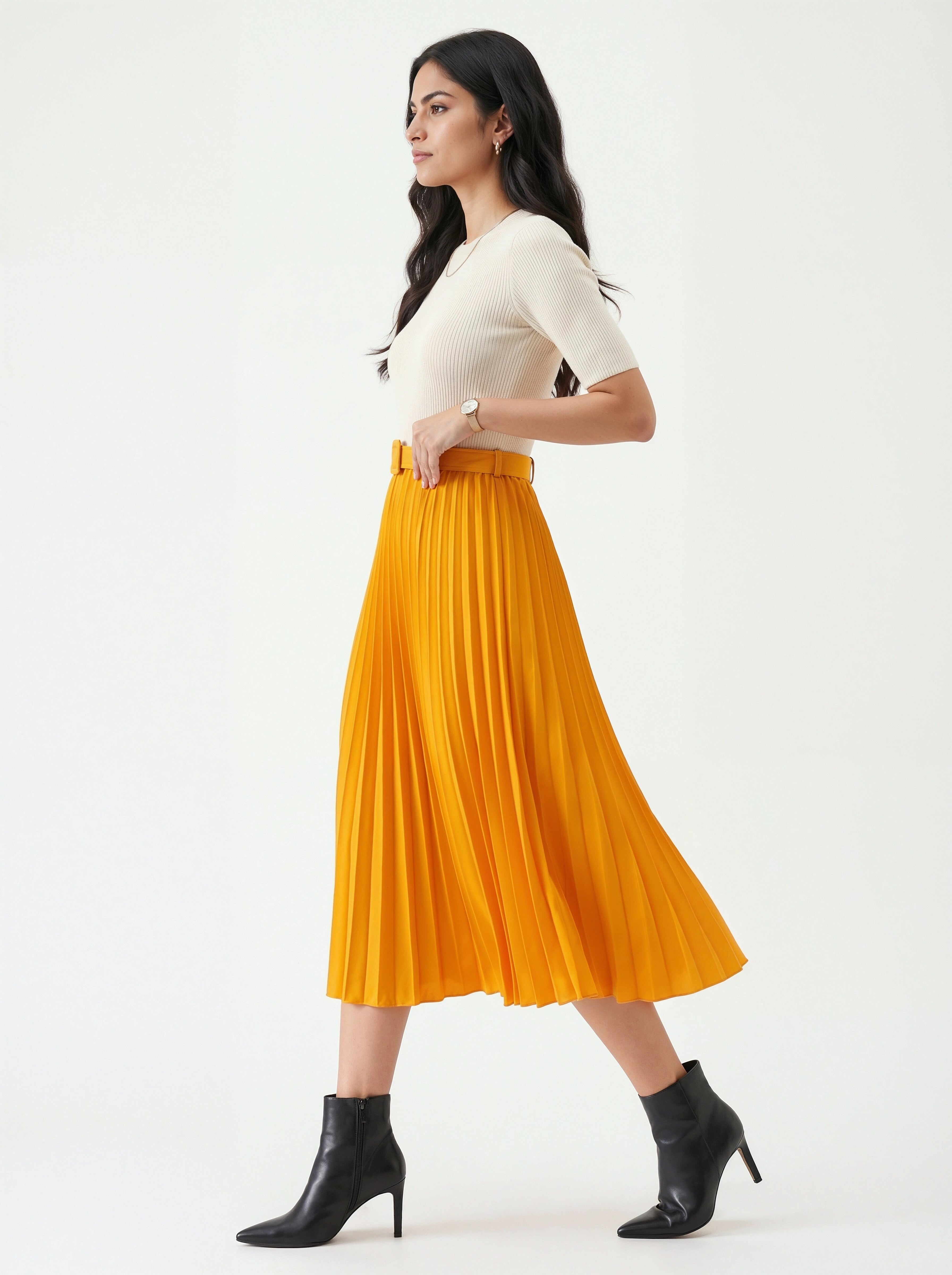 Woman wearing a white top and orange pleated skirt on a white background