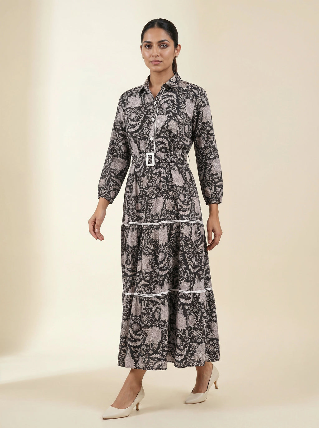 Woman wearing a patterned dress on a beige background