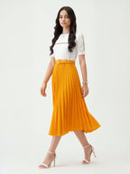 Woman wearing a white top and orange skirt on a white background