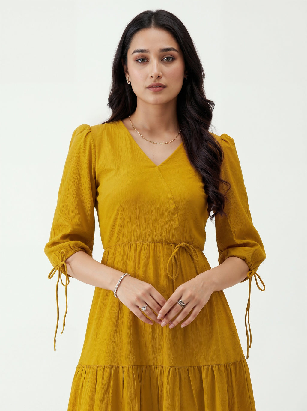 Woman wearing a mustard yellow dress on a white background