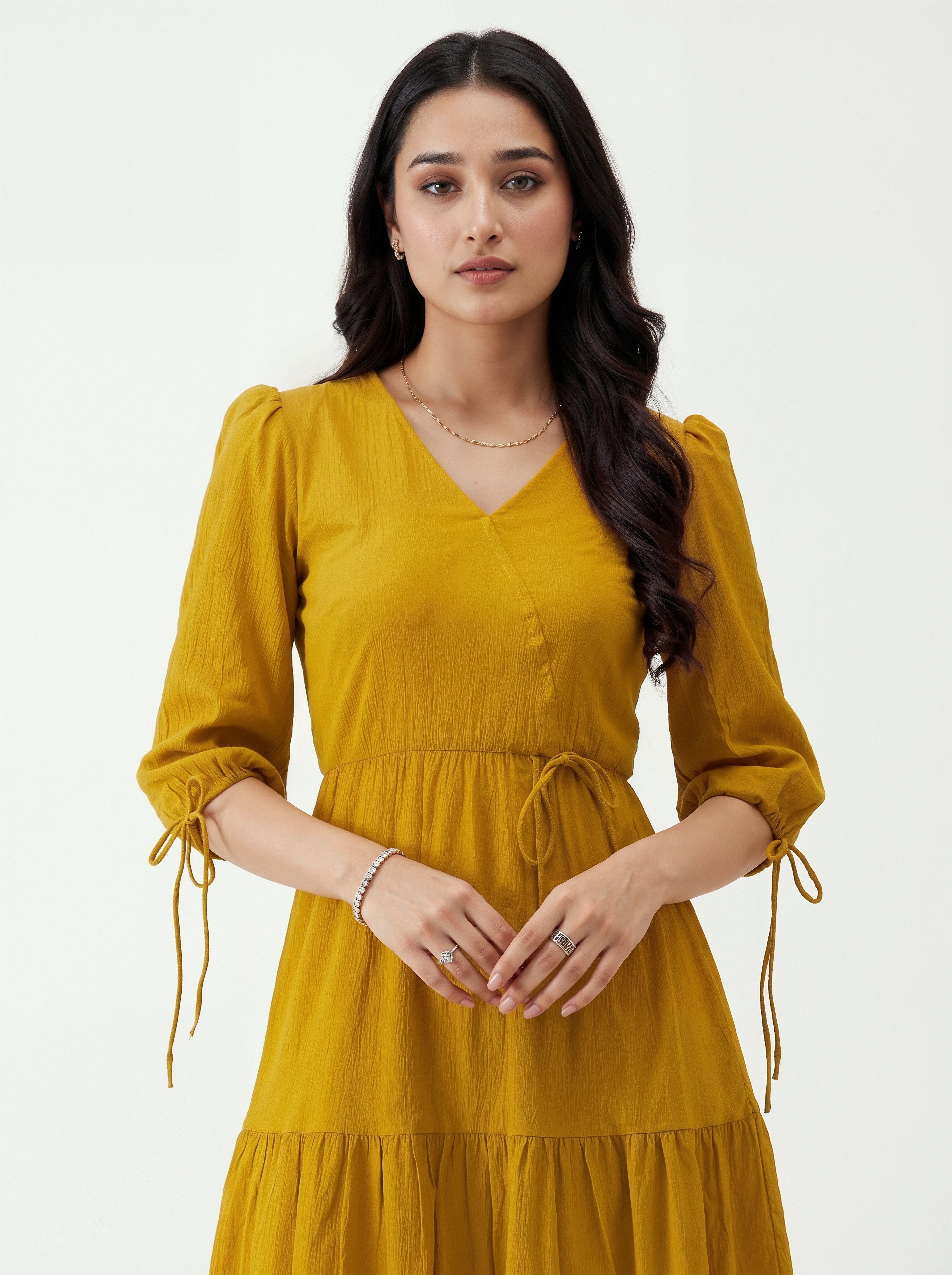 Woman wearing a mustard yellow dress on a white background