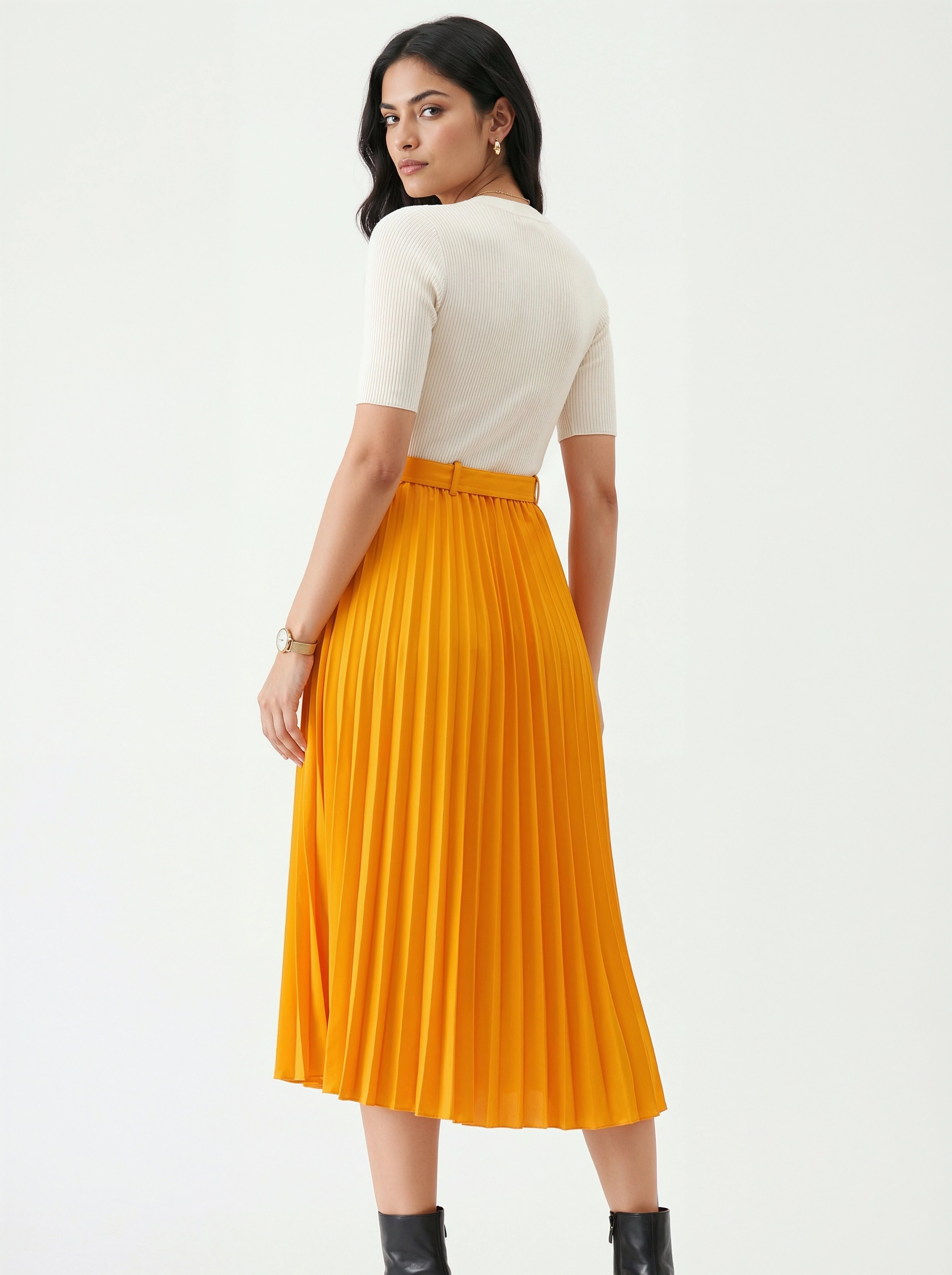 Woman wearing a white top and yellow pleated skirt on a white background