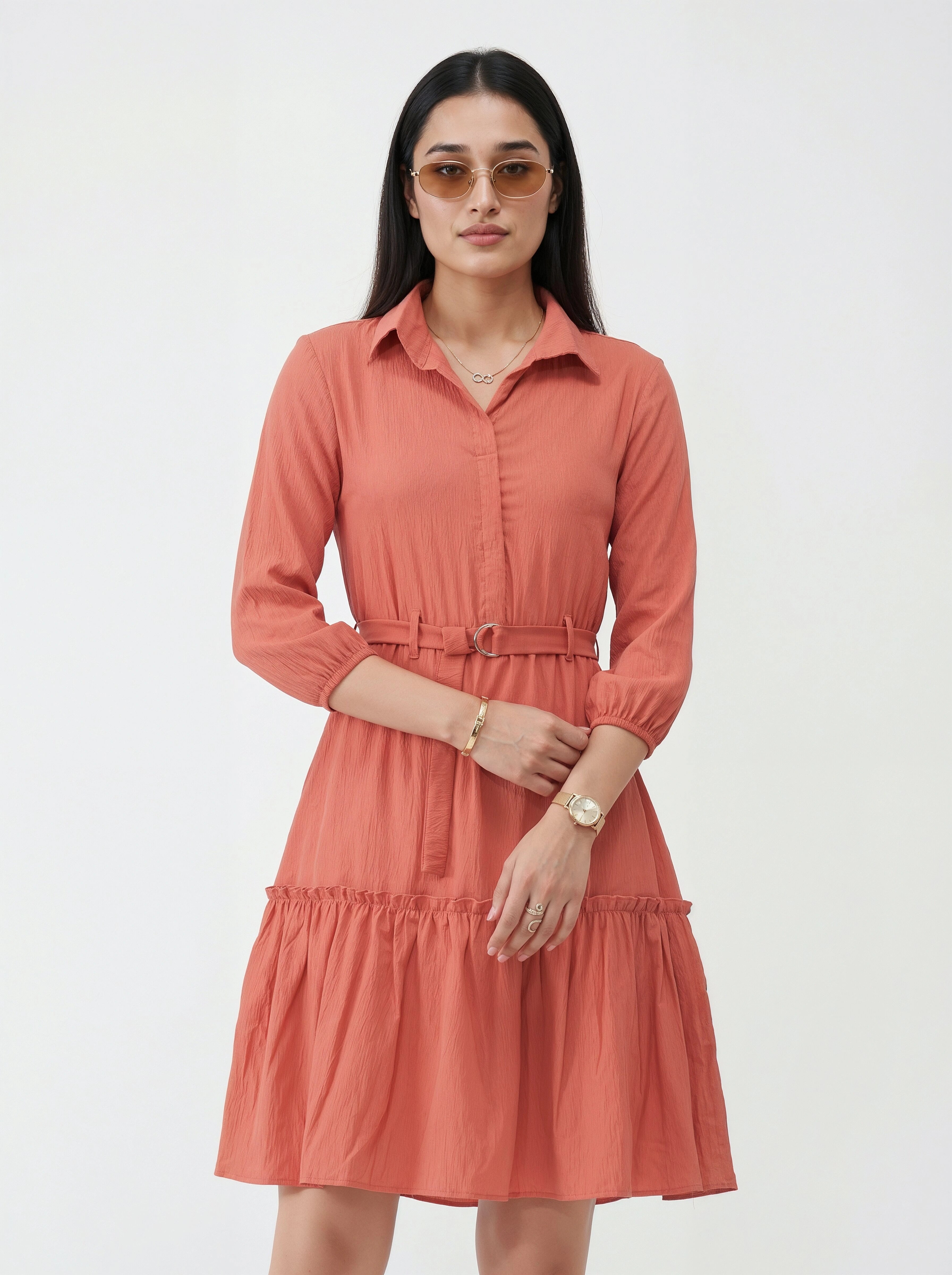 Woman wearing a coral dress with a white background