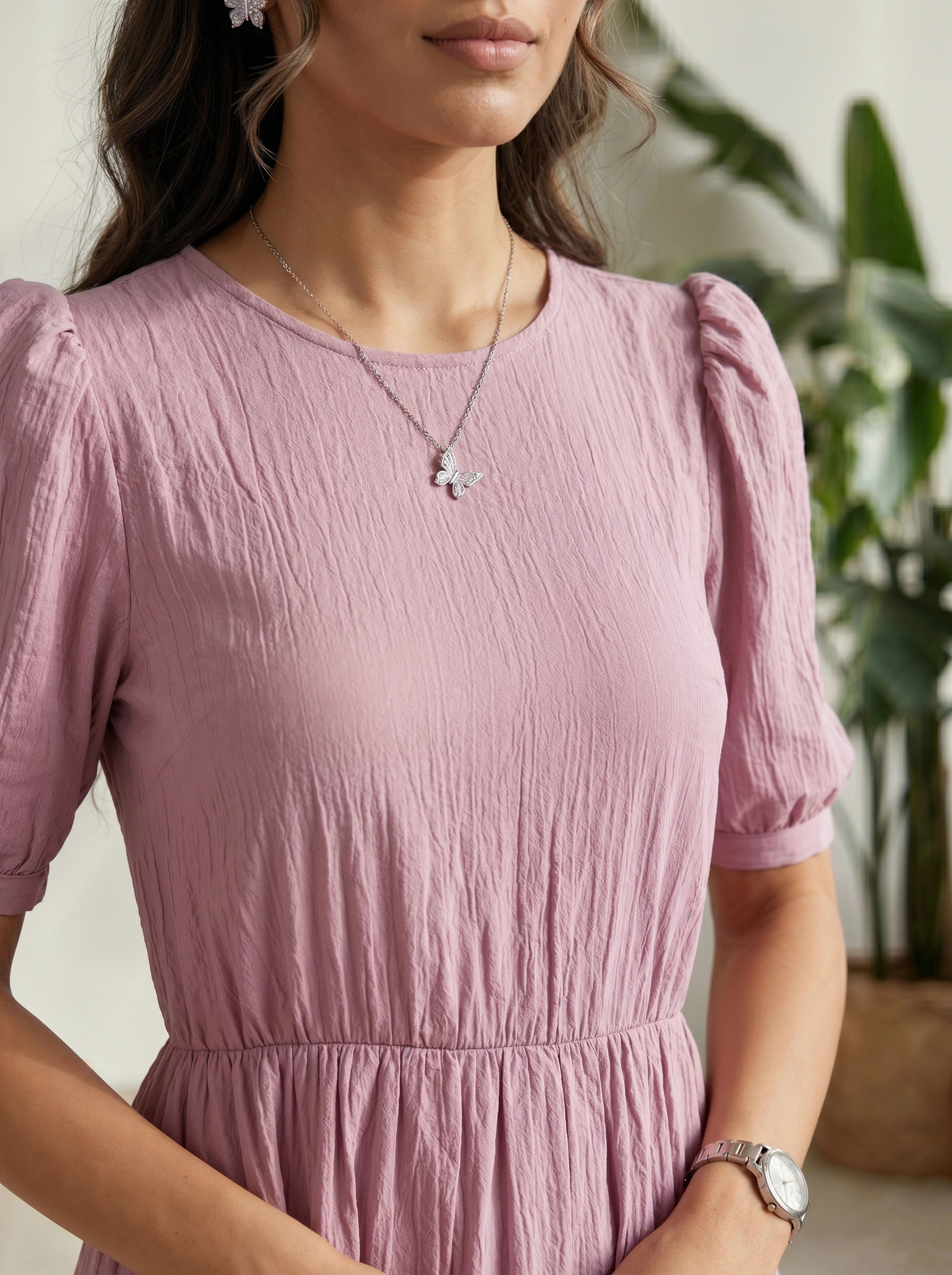 Woman wearing a pink dress with a blurred background