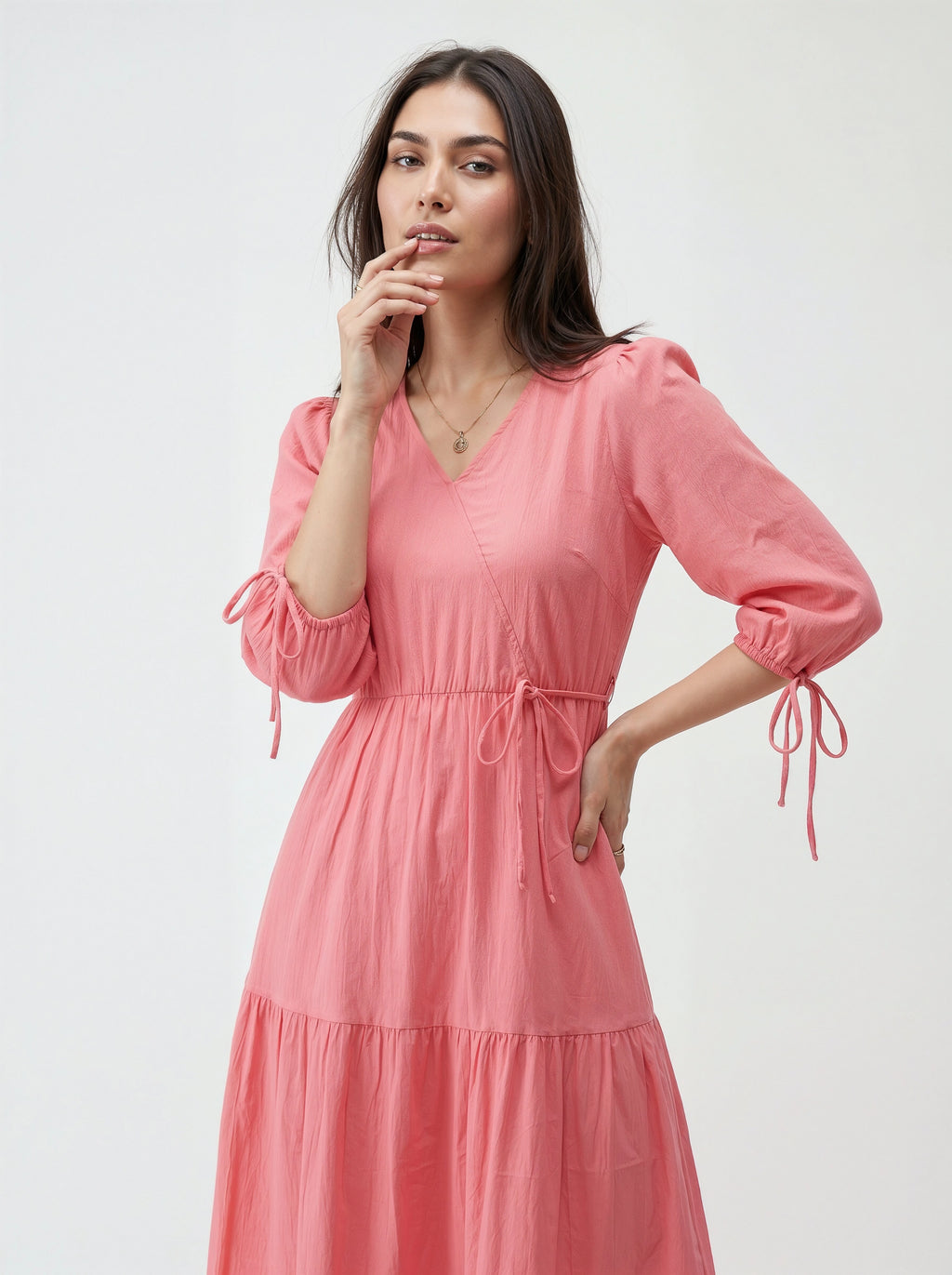 Woman wearing a pink dress against a white background