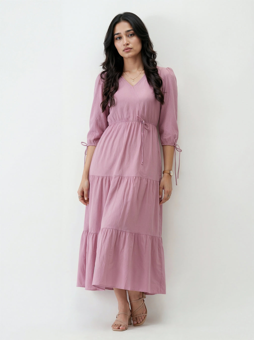 Woman wearing a pink dress against a white background