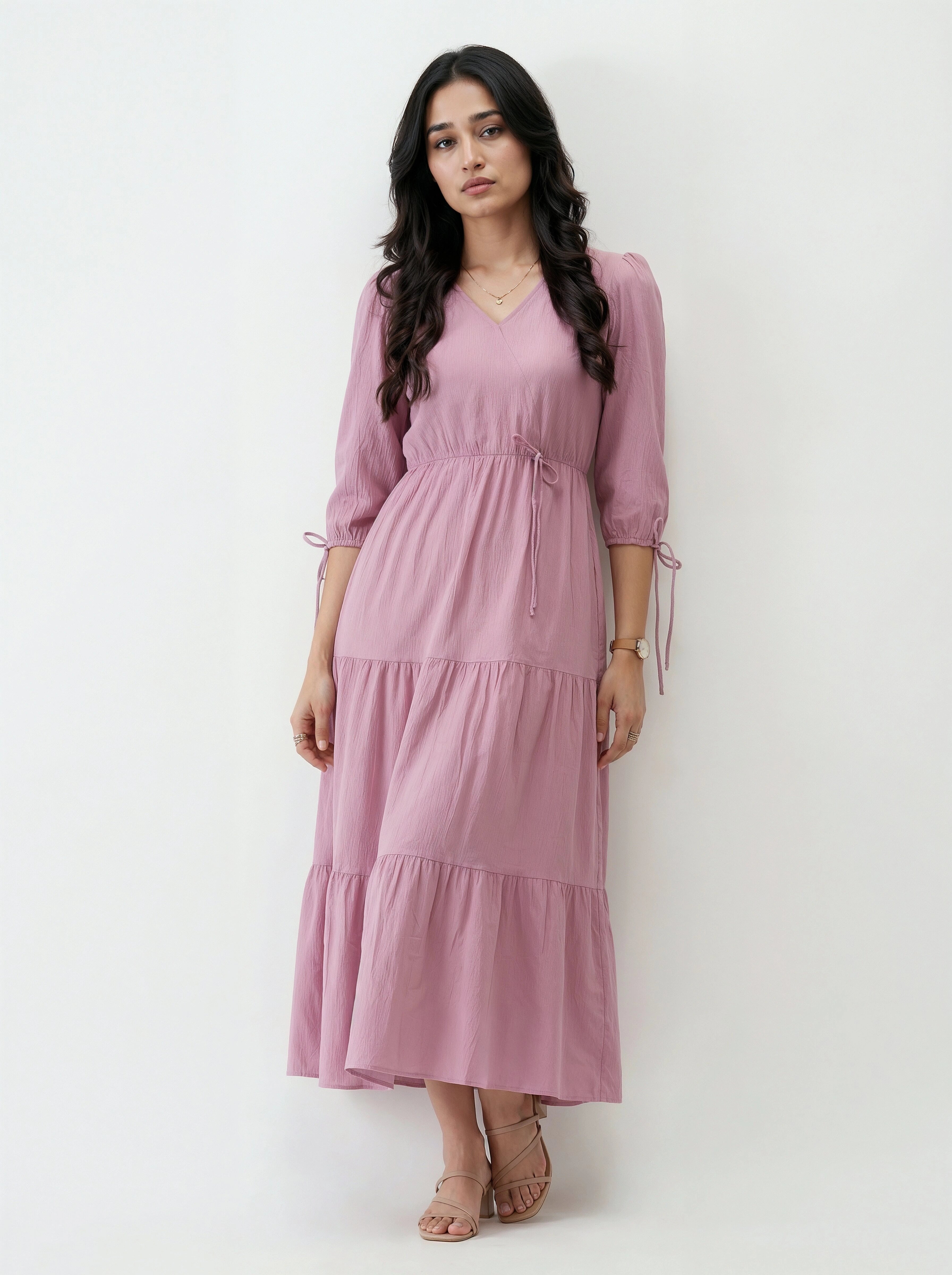 Woman wearing a pink dress against a white background