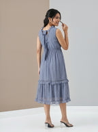 Woman wearing a blue dress against a neutral background