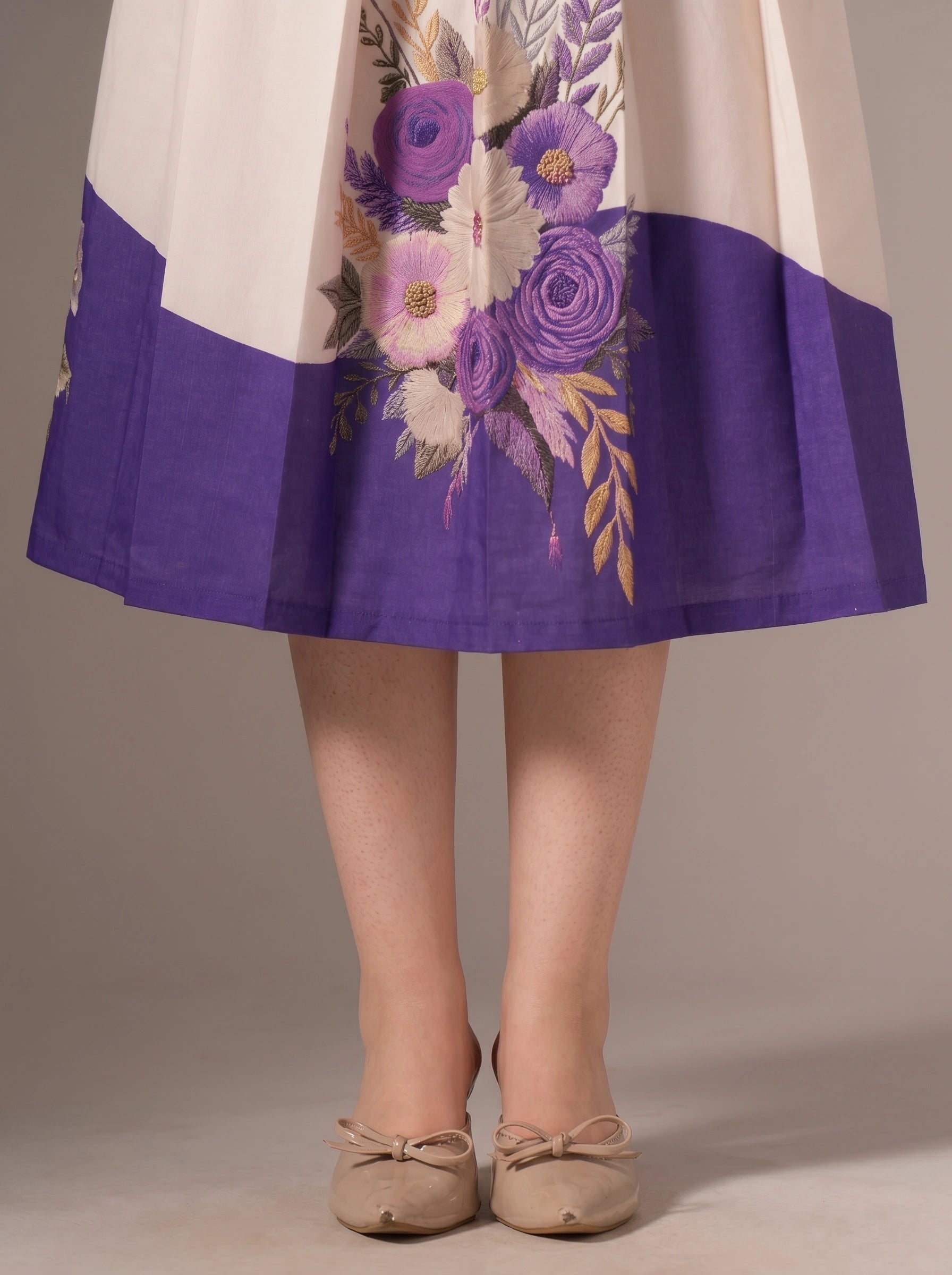 Skirt with floral design and purple bottom section on a neutral background