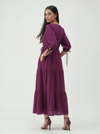 Woman wearing a purple dress on a white background