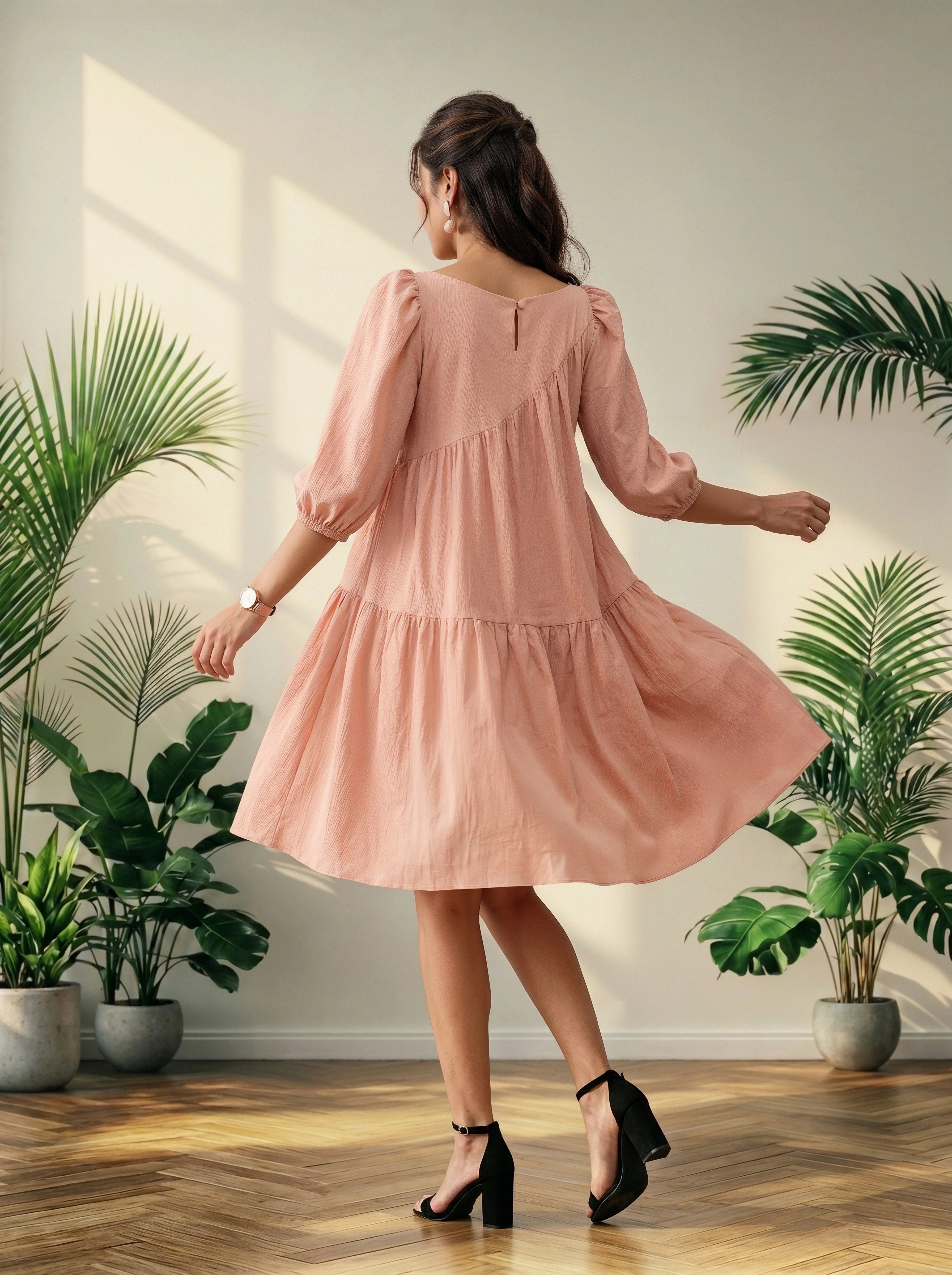 Woman in a pink dress standing in a room with plants