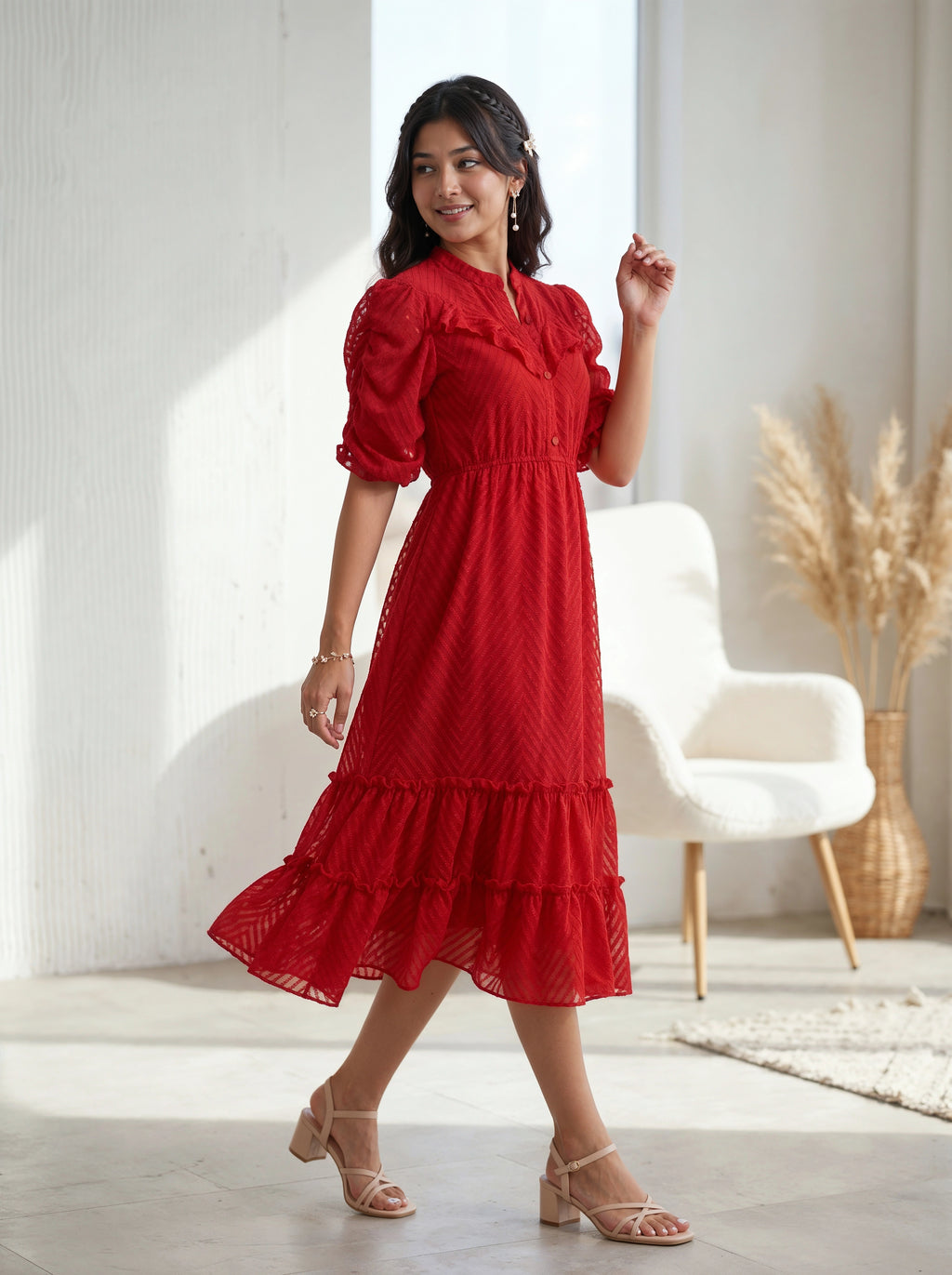 Woman wearing a navy blue dress with ruffled details against a beige background
