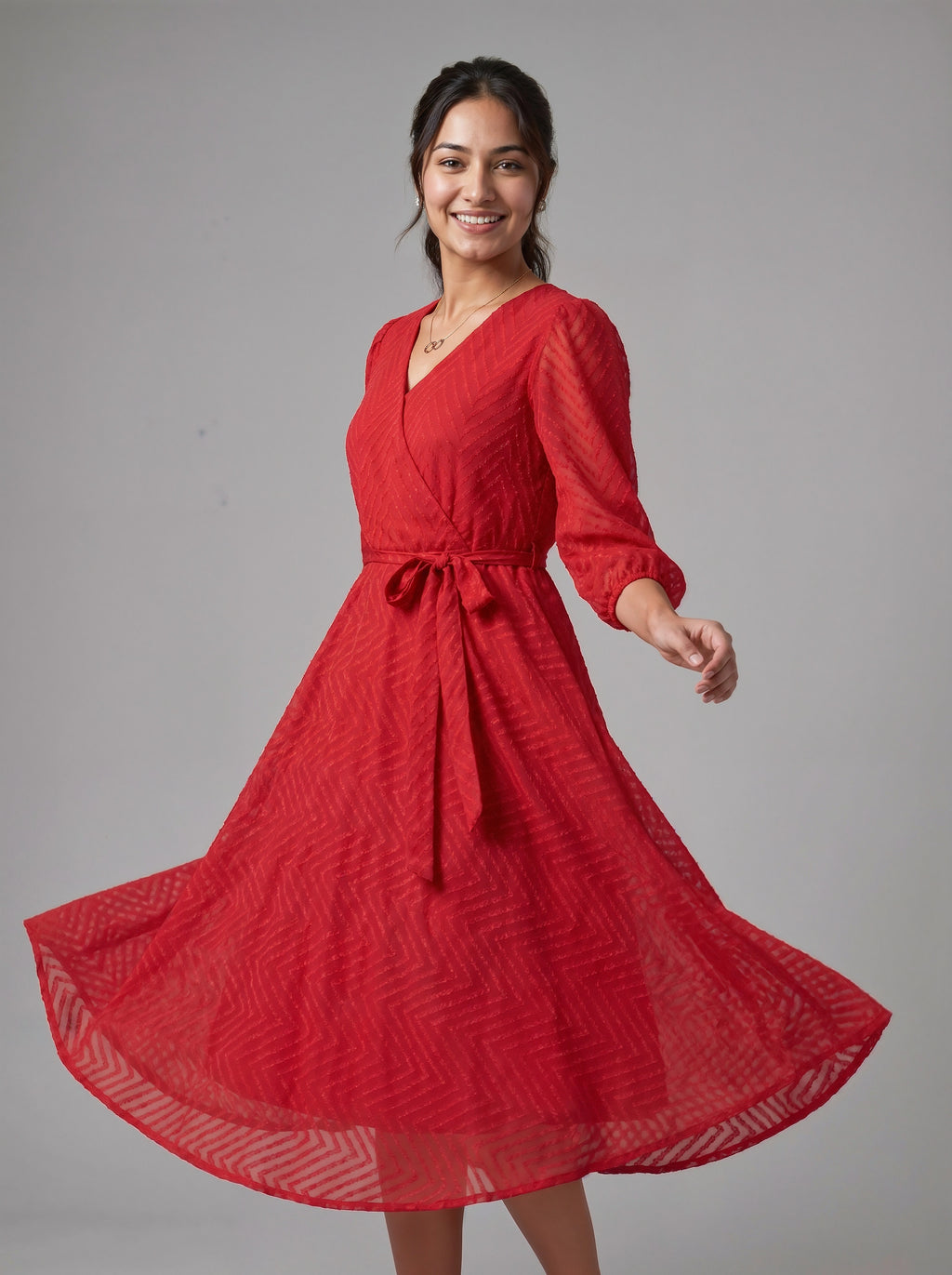 Woman wearing a red dress with a pattern on a gray background