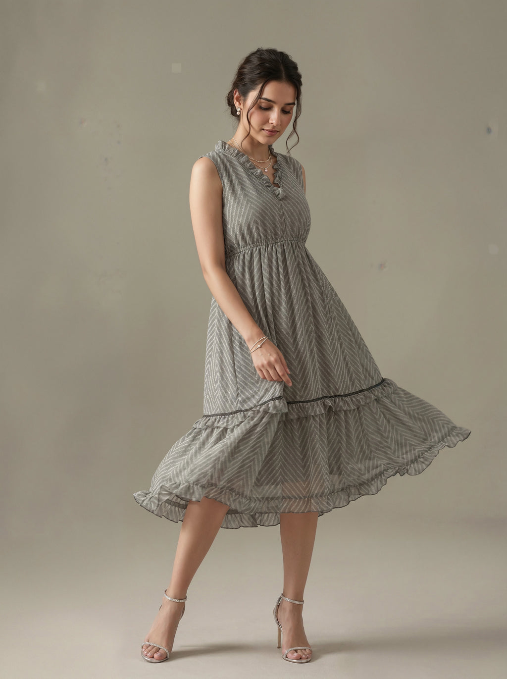 Woman wearing a sleeveless, patterned dress against a neutral background