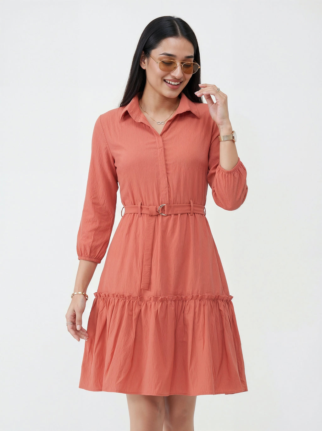Woman wearing a coral dress with a white background