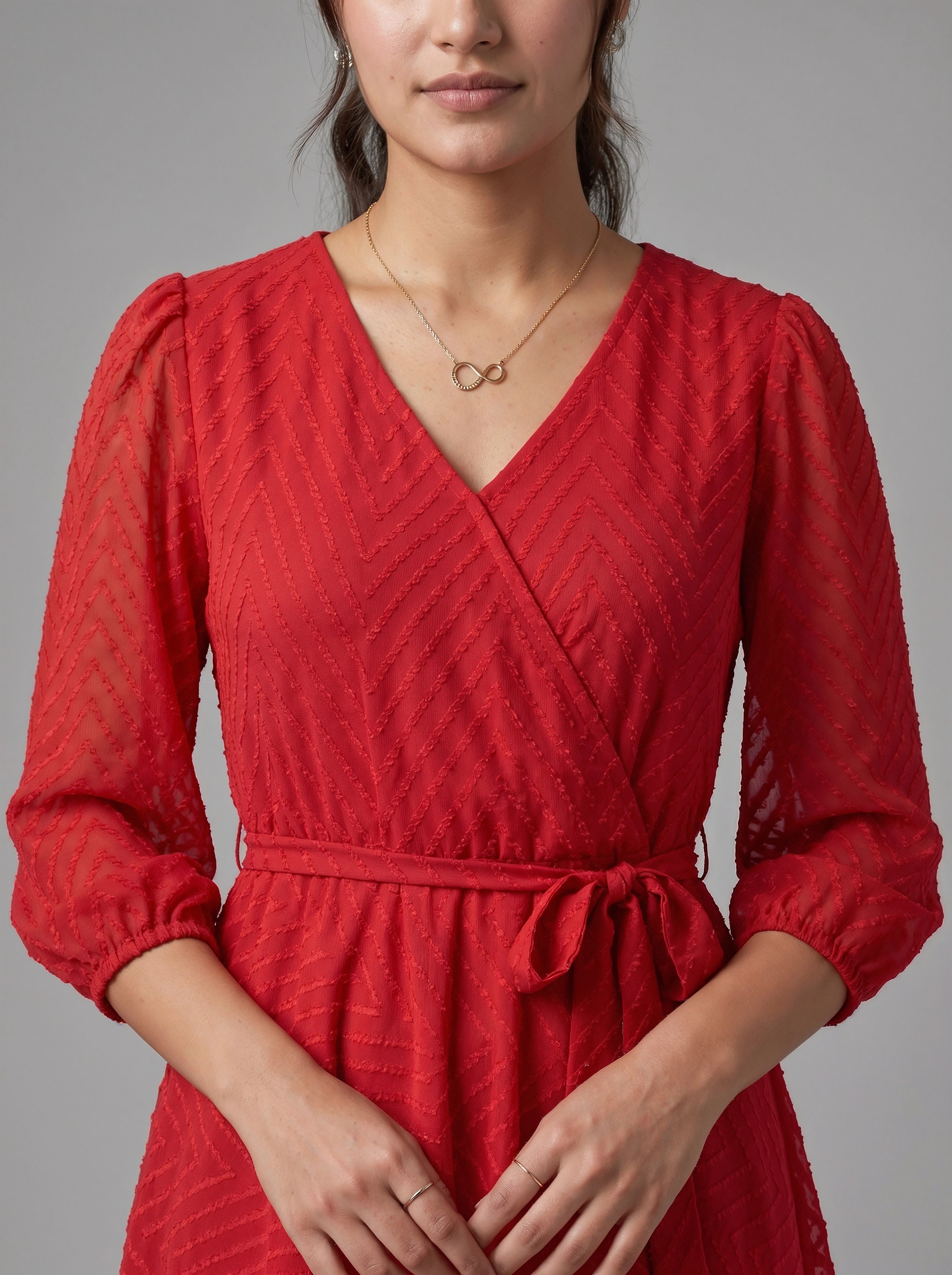 Red dress worn by a person on a gray background