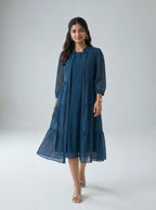 Woman wearing a blue dress against a white background