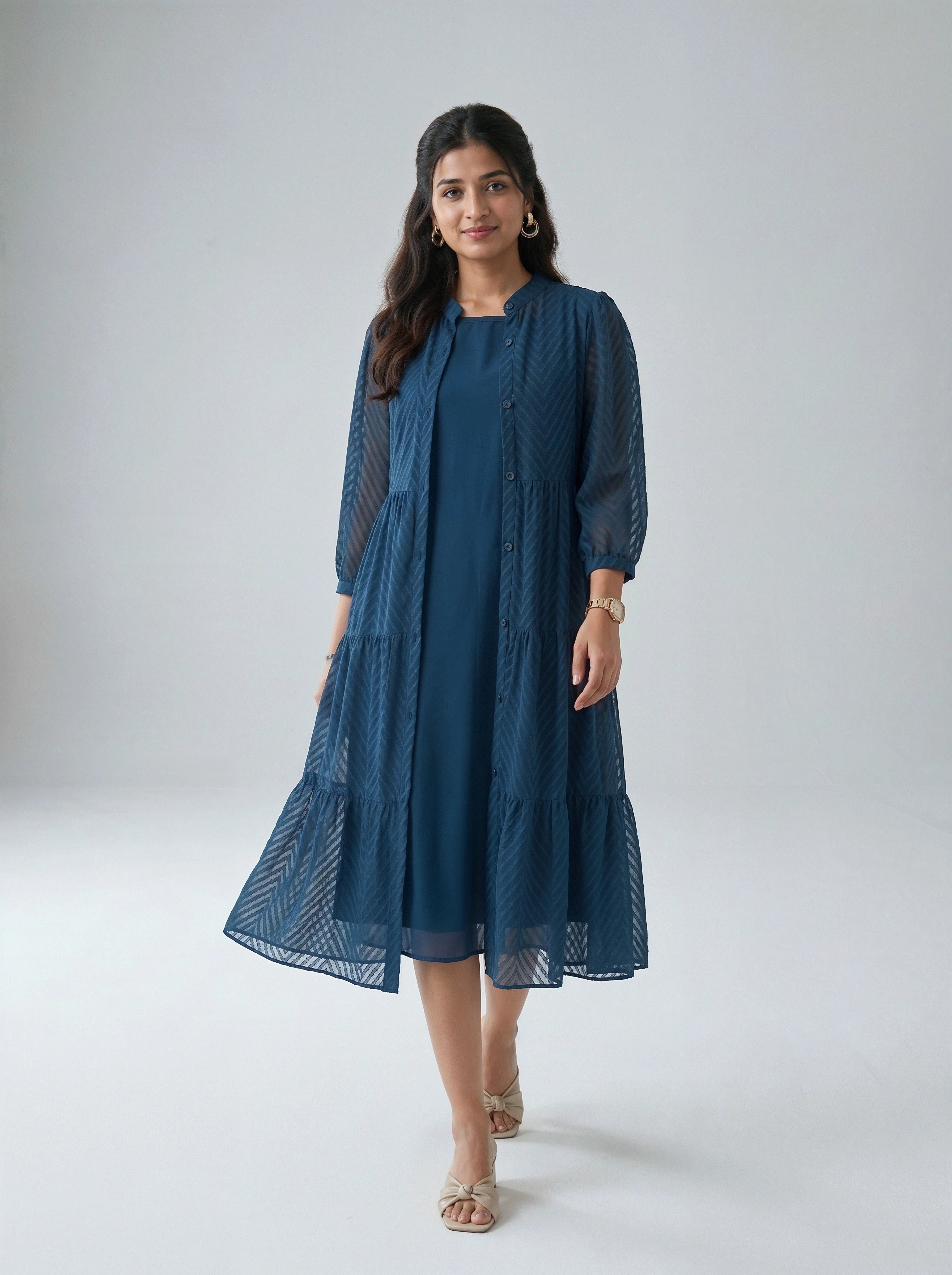 Woman wearing a blue dress against a white background