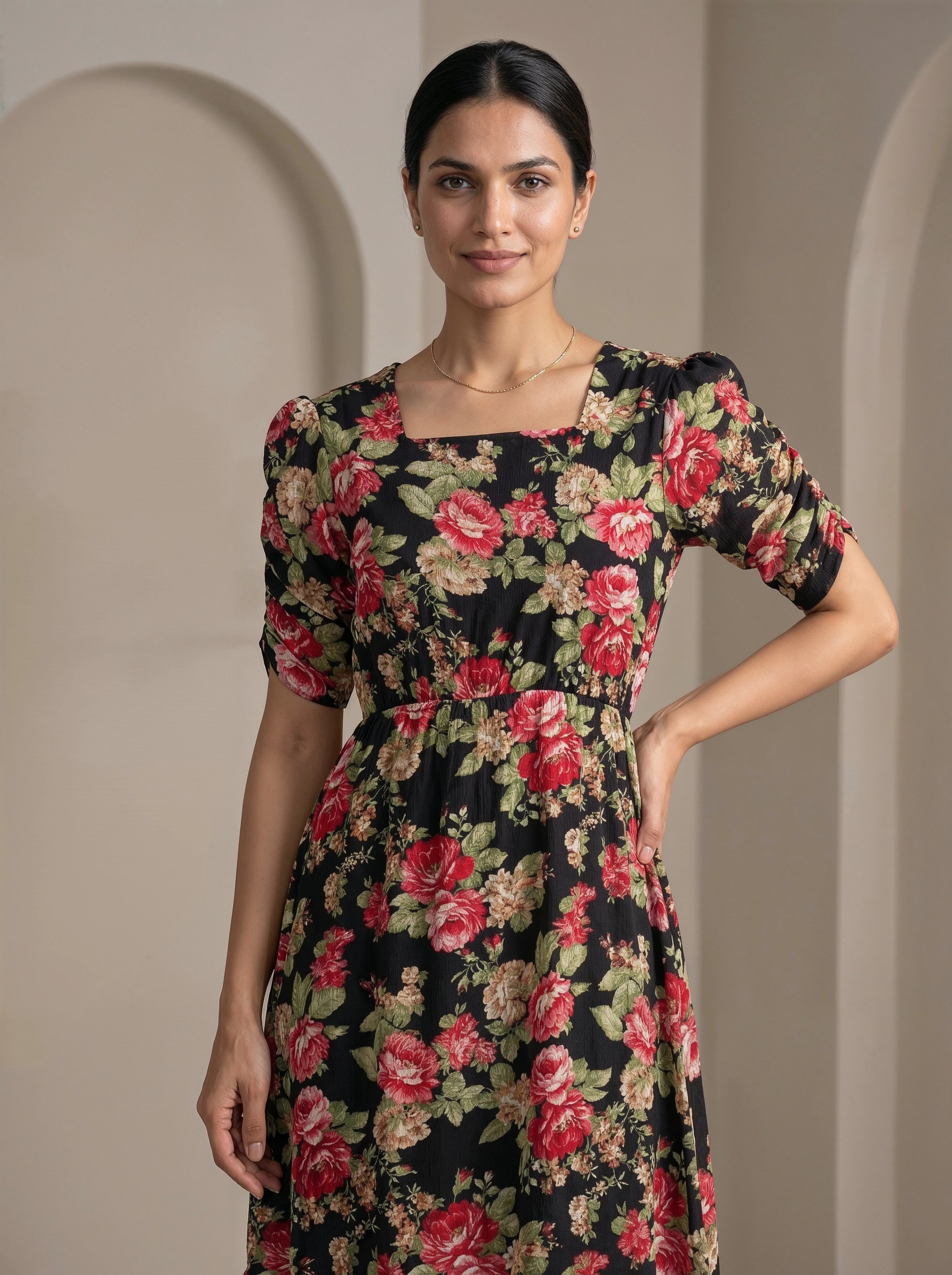 Woman wearing a floral dress against a neutral background