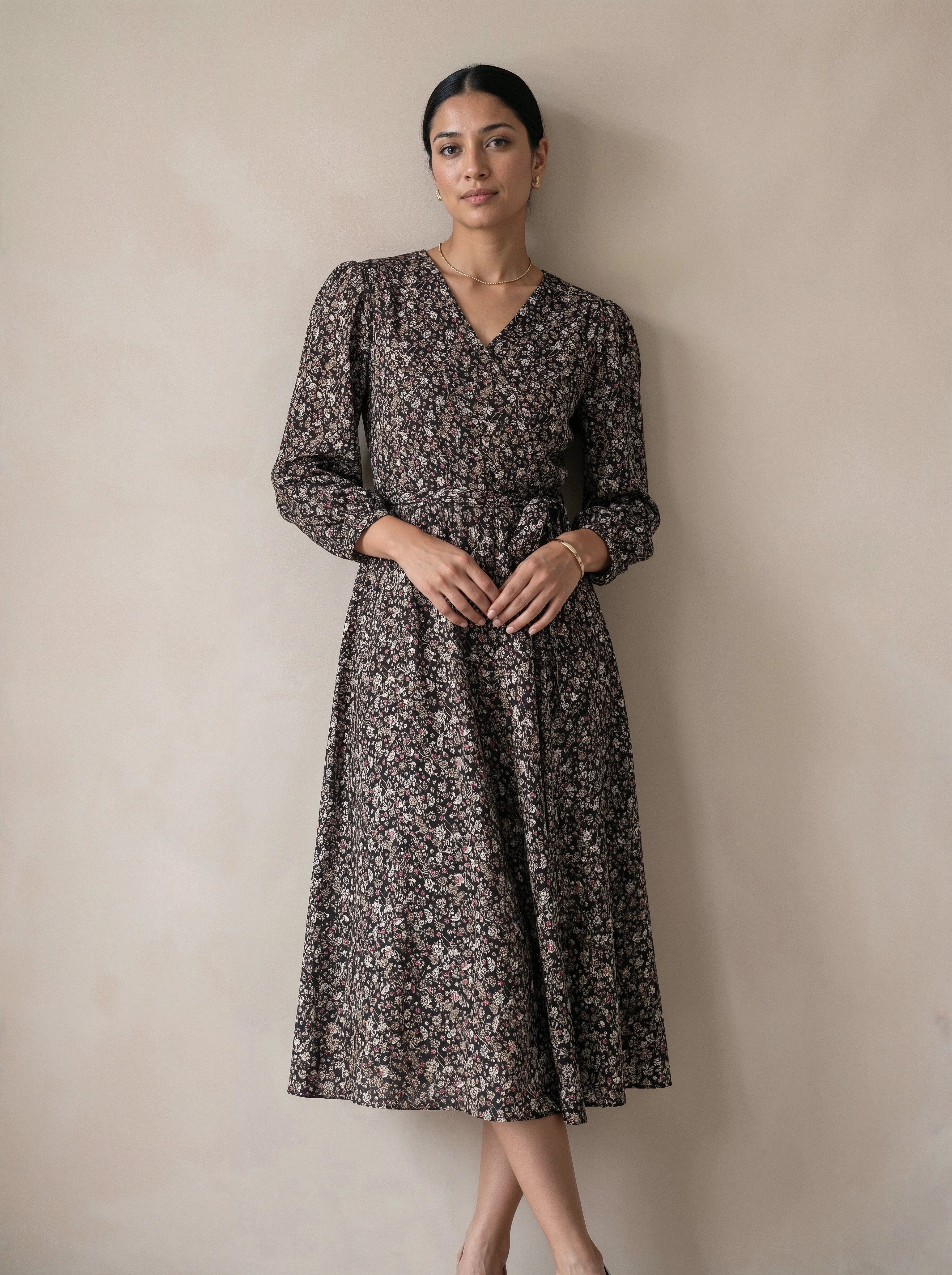 Woman wearing a floral dress against a plain background