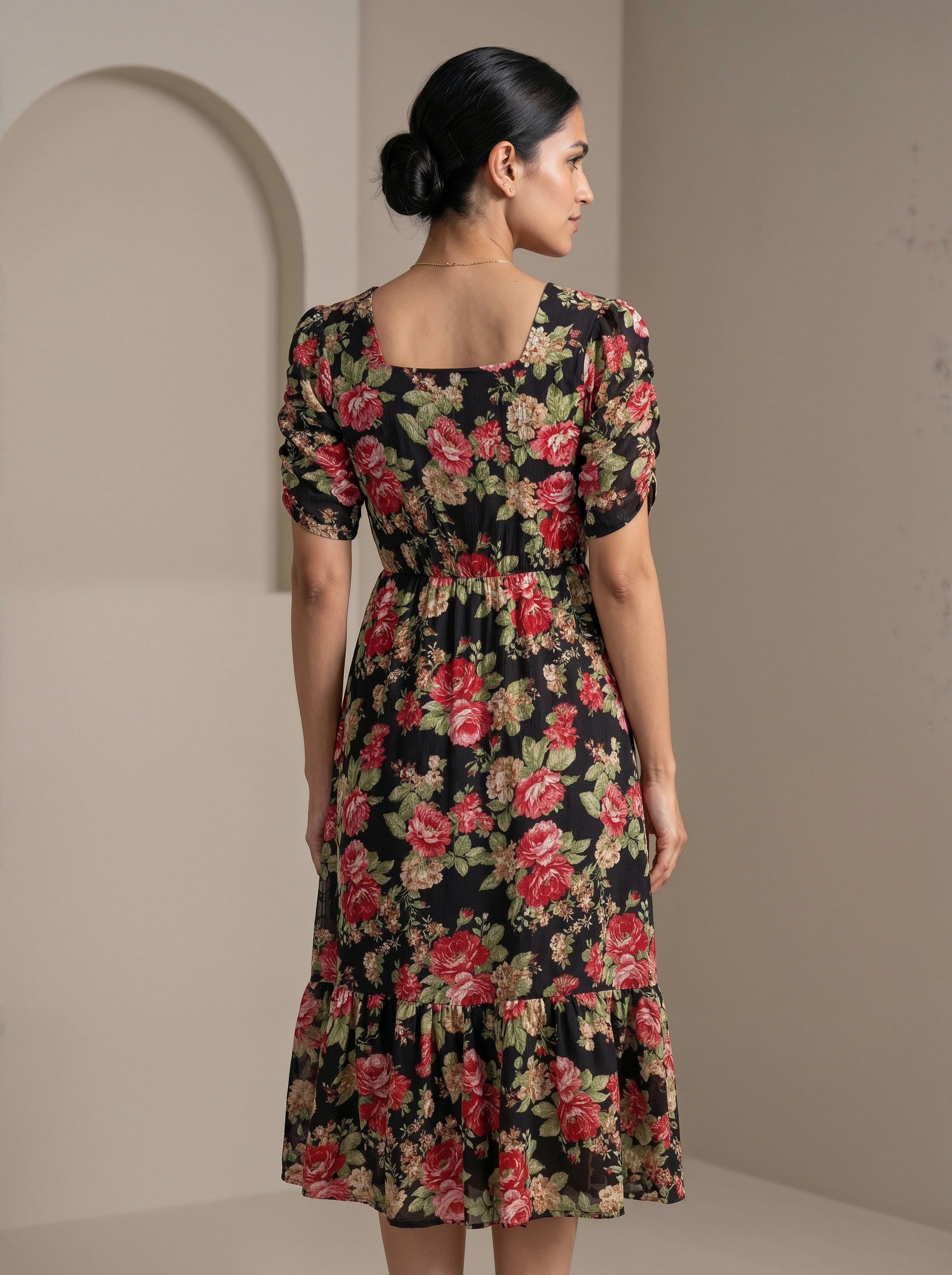 Woman wearing a floral dress with a neutral background