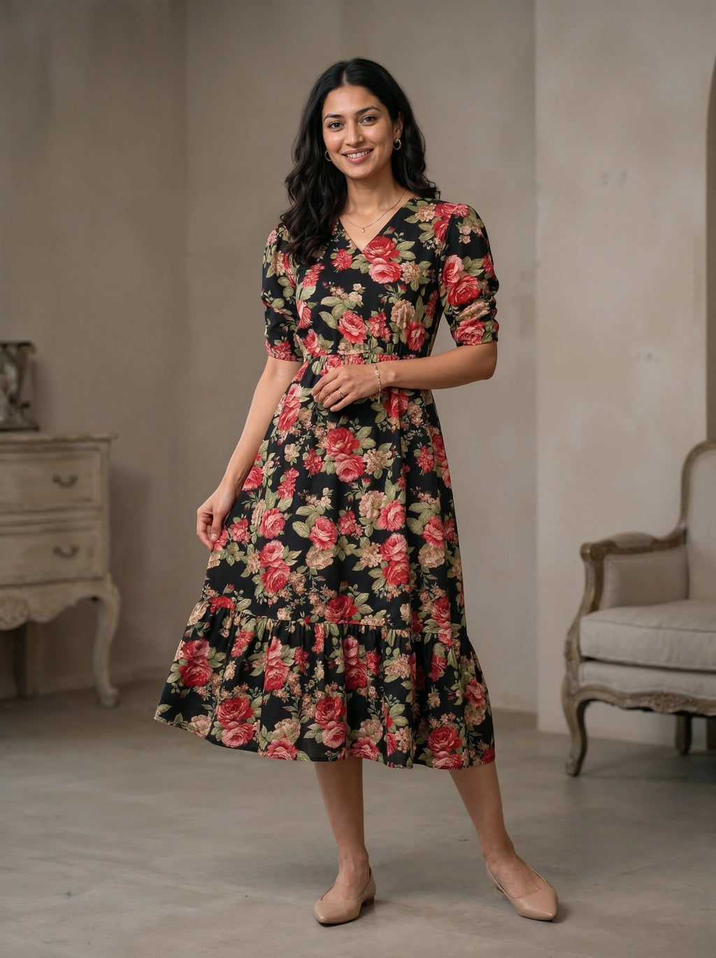 Woman wearing a floral dress standing in a room with a neutral background
