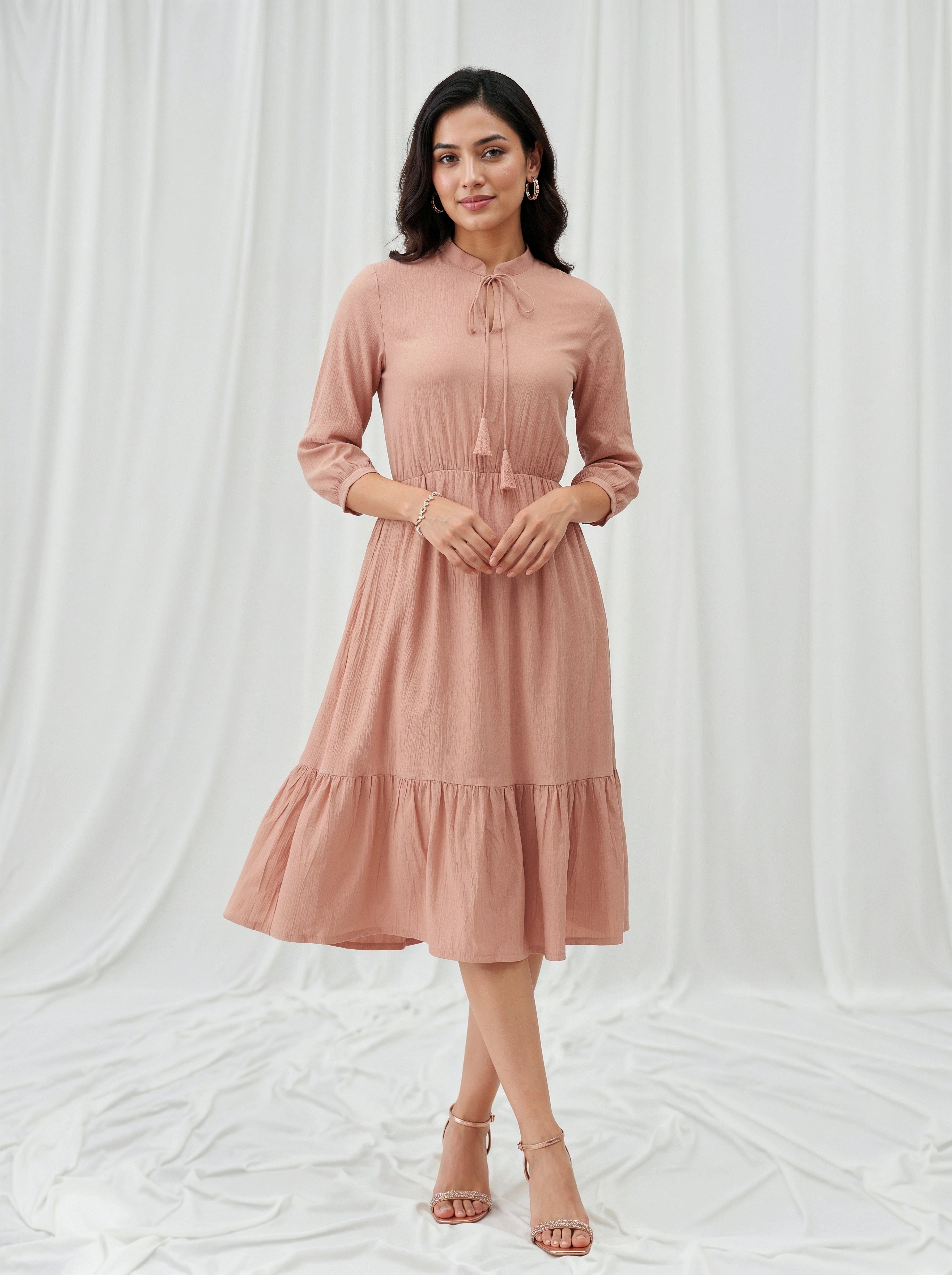 Woman wearing a pink dress against a white background