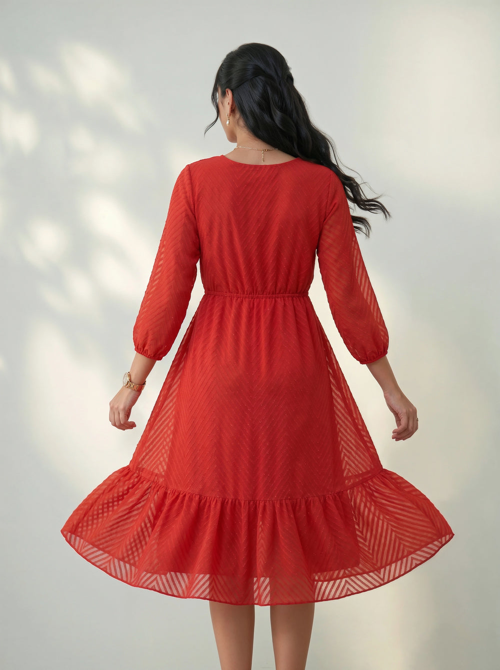 Red dress with long sleeves on a plain background