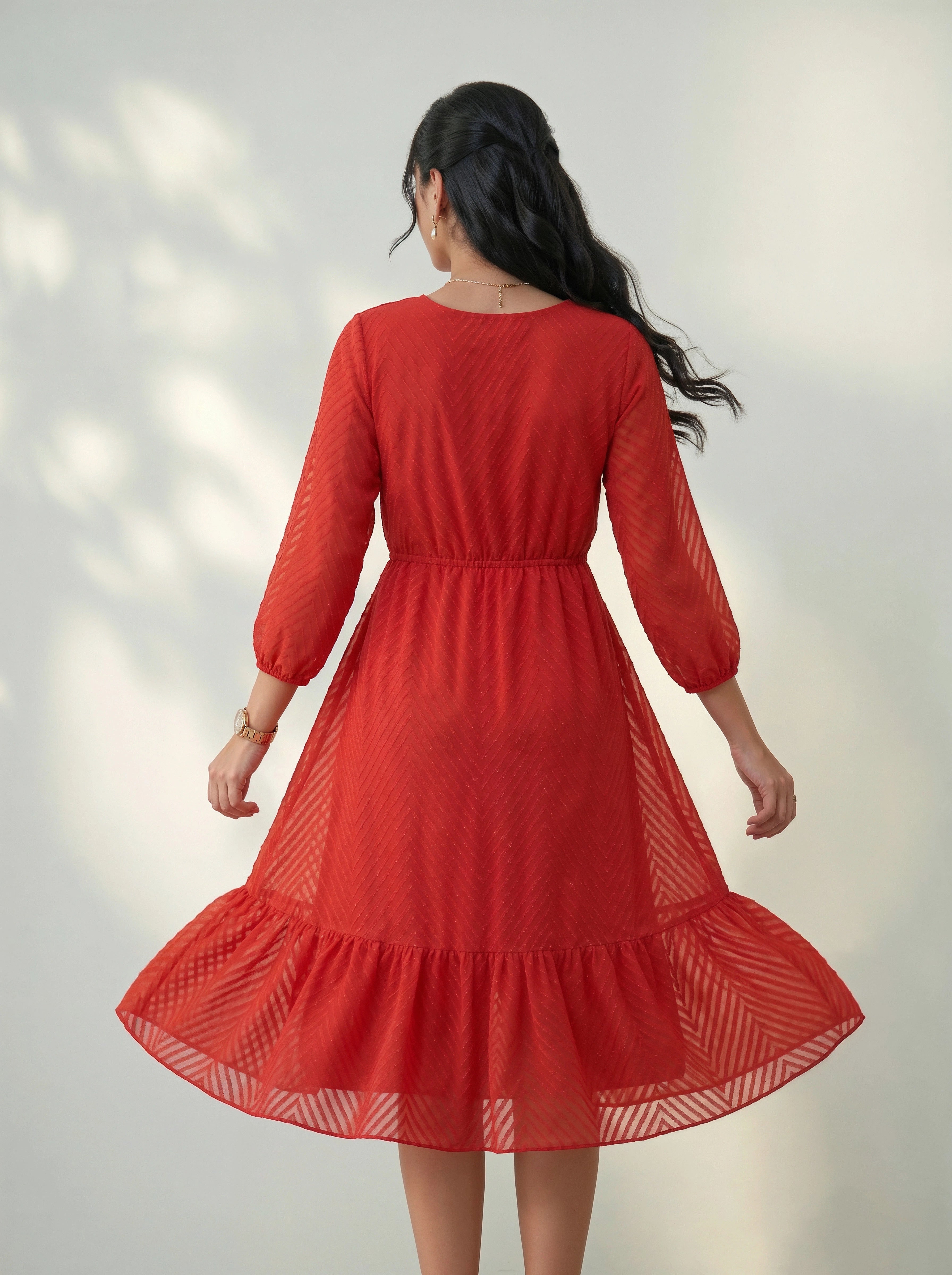 Red dress with long sleeves on a plain background