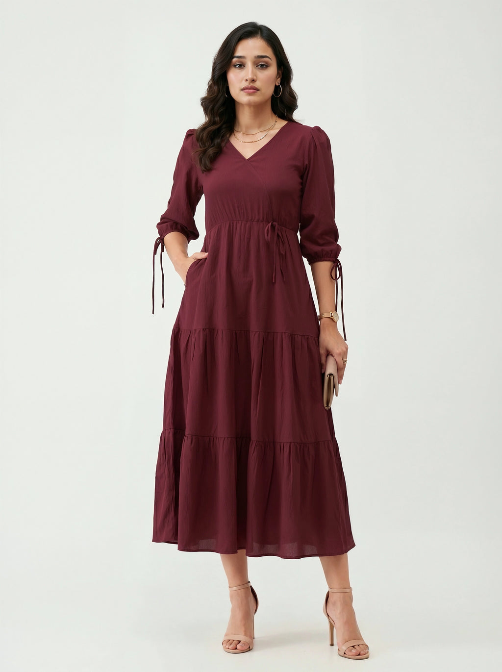 Woman wearing a burgundy dress on a white background