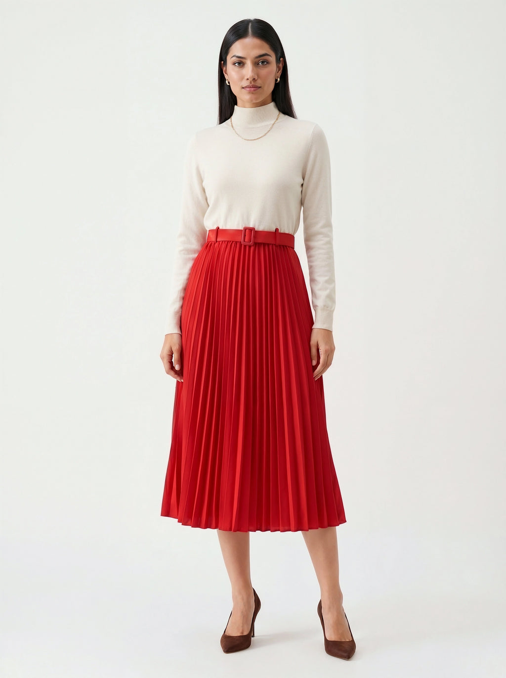Woman wearing a red pleated skirt and cream turtleneck on a white background