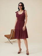 Maroon dress with wooden chair background