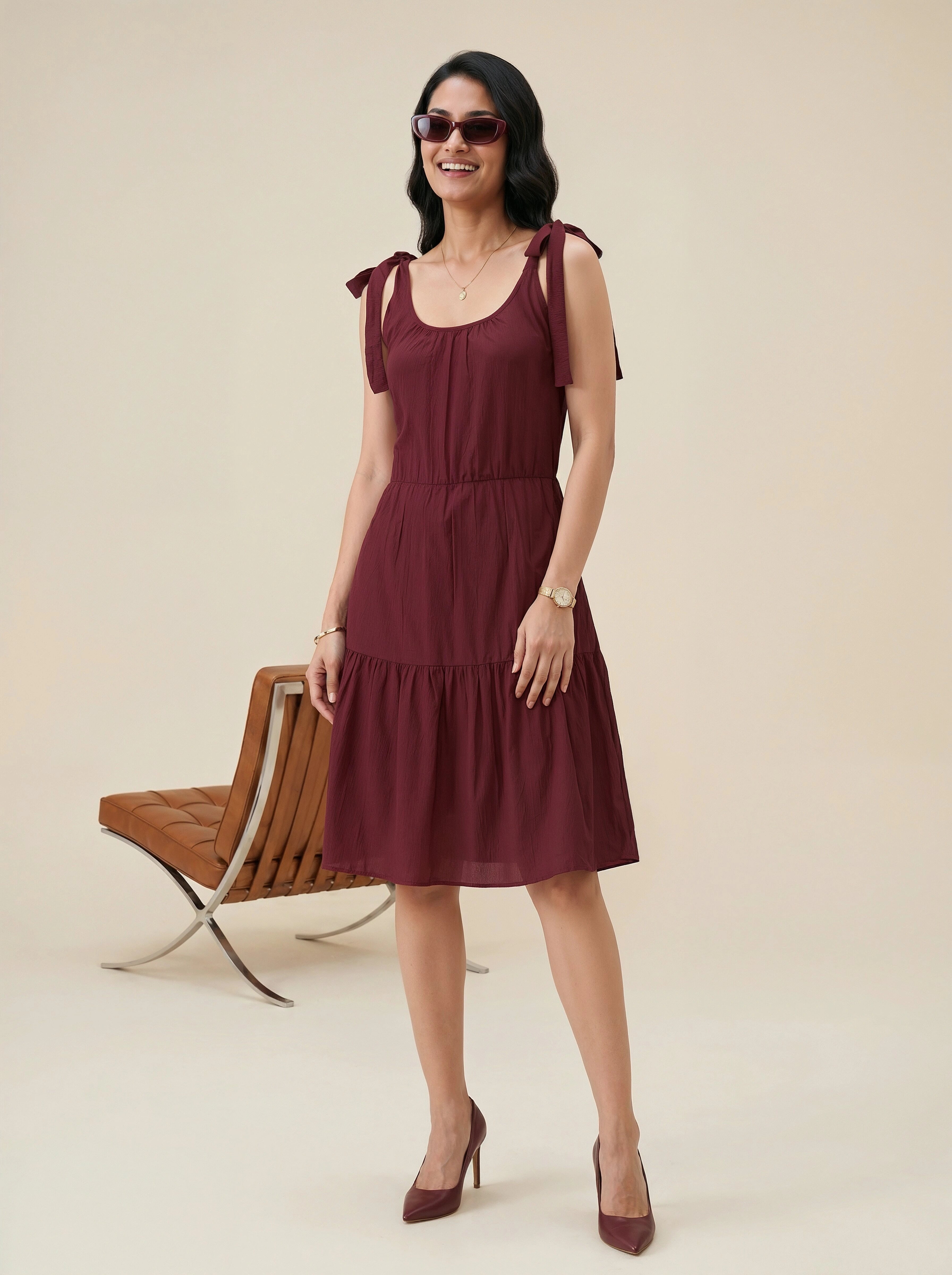 Maroon dress with wooden chair background