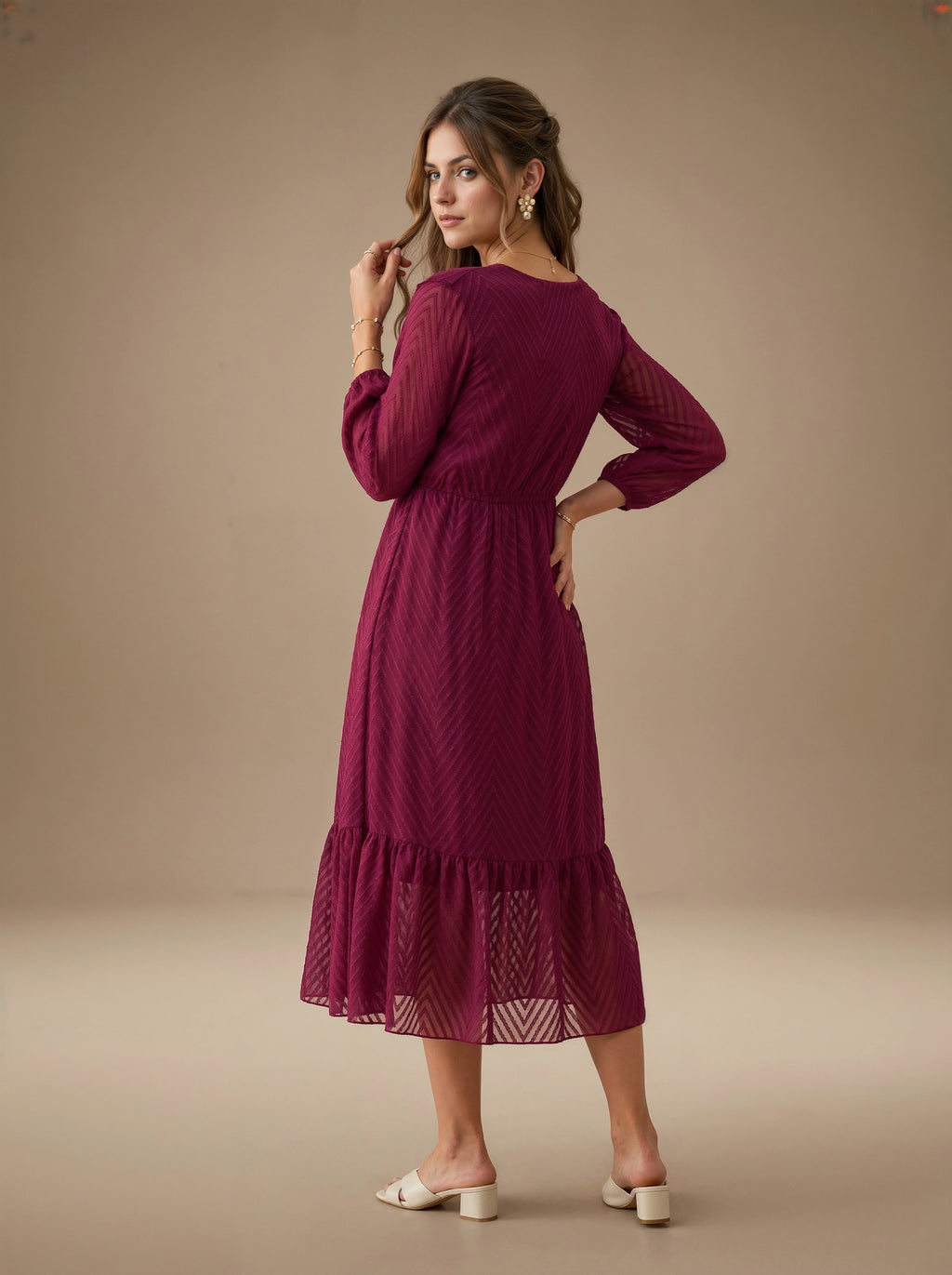 Woman wearing a burgundy dress against a beige background