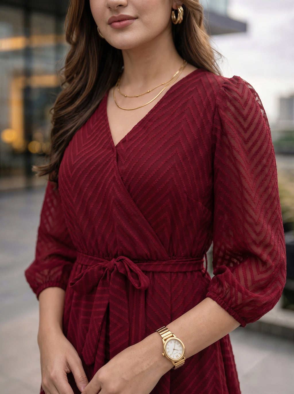 Woman wearing a red dress with long sleeves and a blurred background