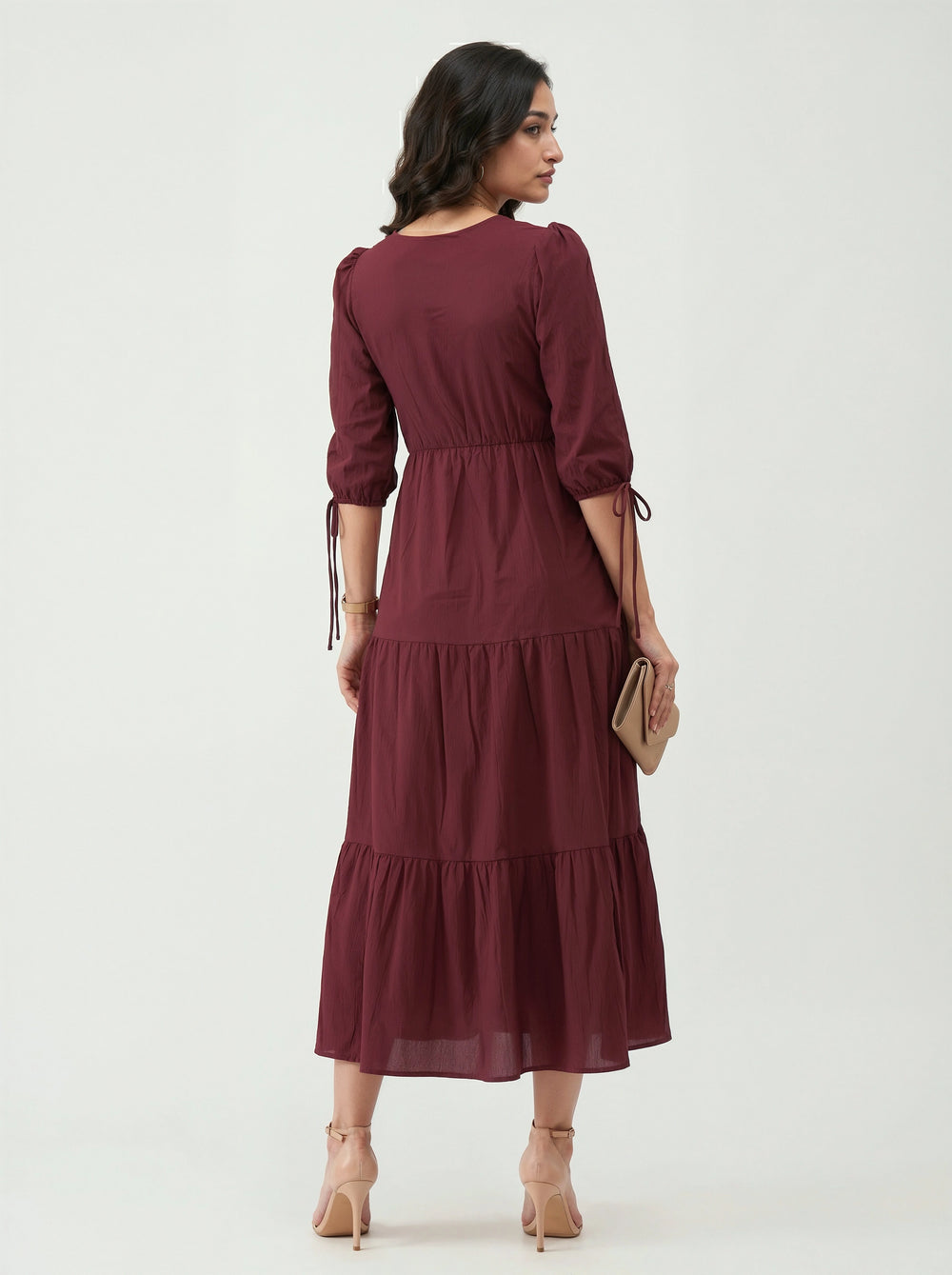 Woman wearing a burgundy dress on a white background