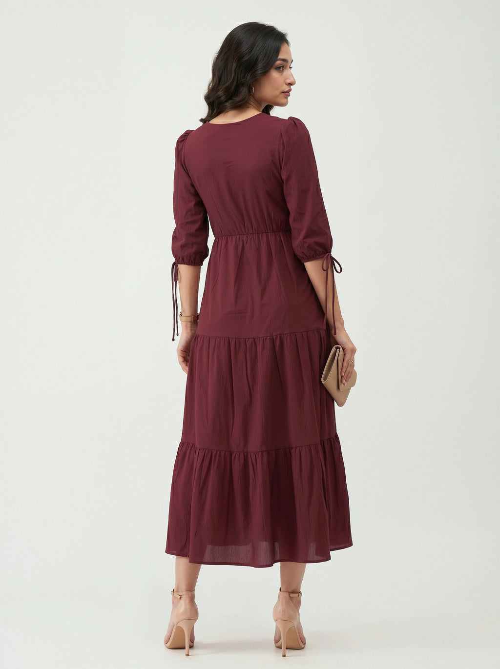 Woman wearing a burgundy dress on a white background